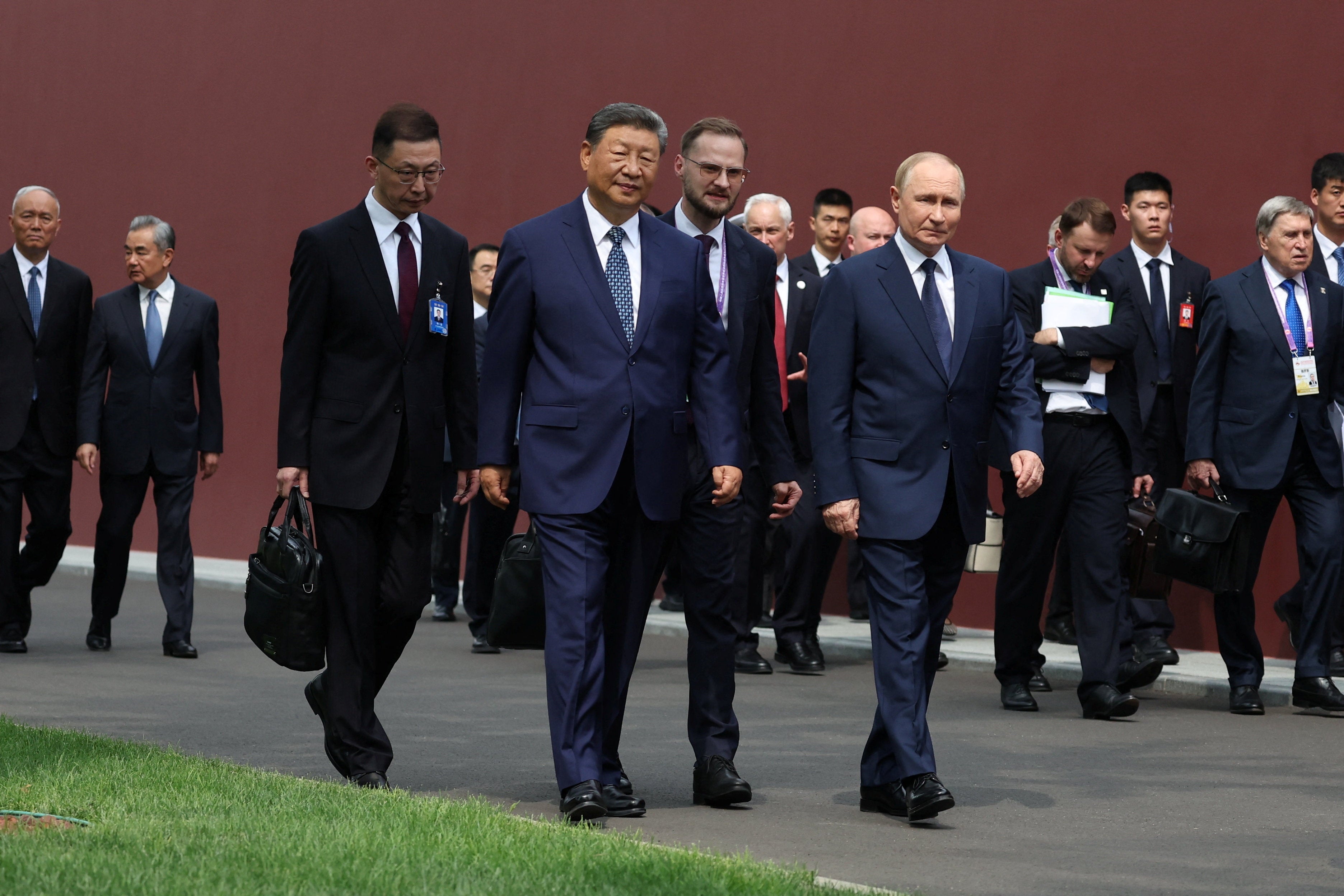 Xi Jinping and Vladimir Putin walk at the personal residence of the Chinese leader Zhongnanhai in Beijing