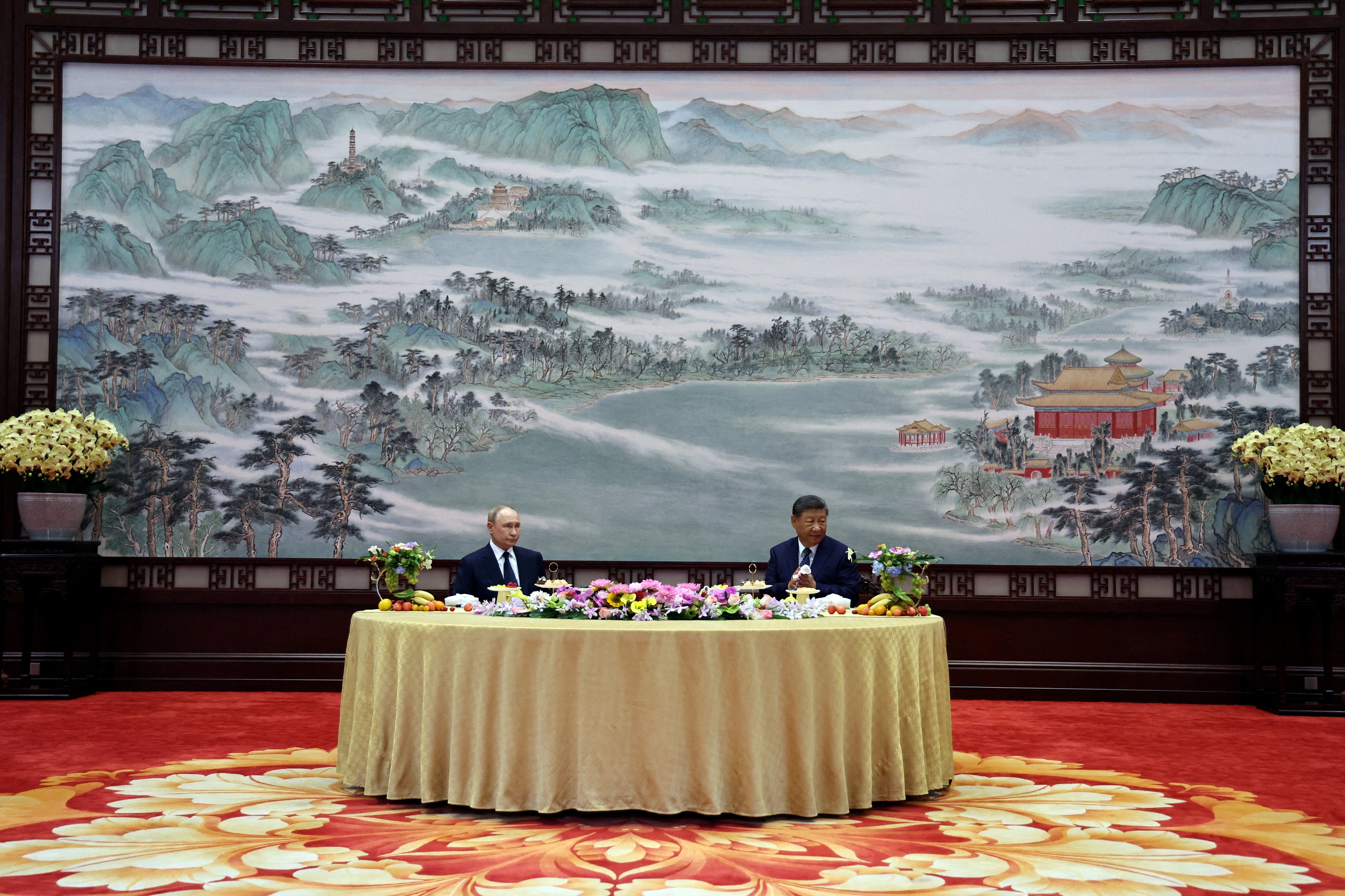 Vladimir Putin and Xi Jinping attend a meeting in Beijing