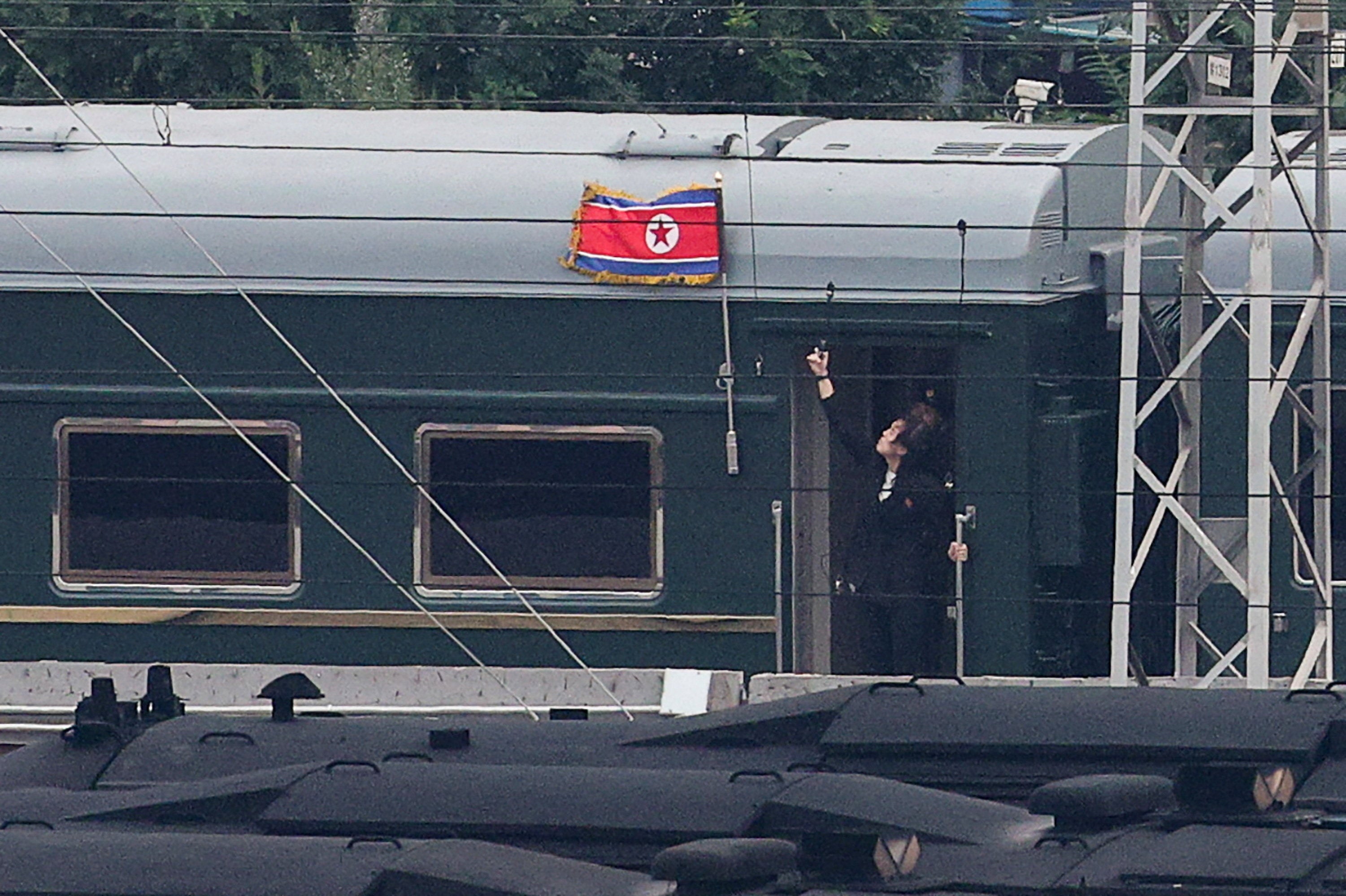 A North Korean flag flutters from a train believed to be carrying North Korean leader Kim Jong Un, as it arrives in Beijing