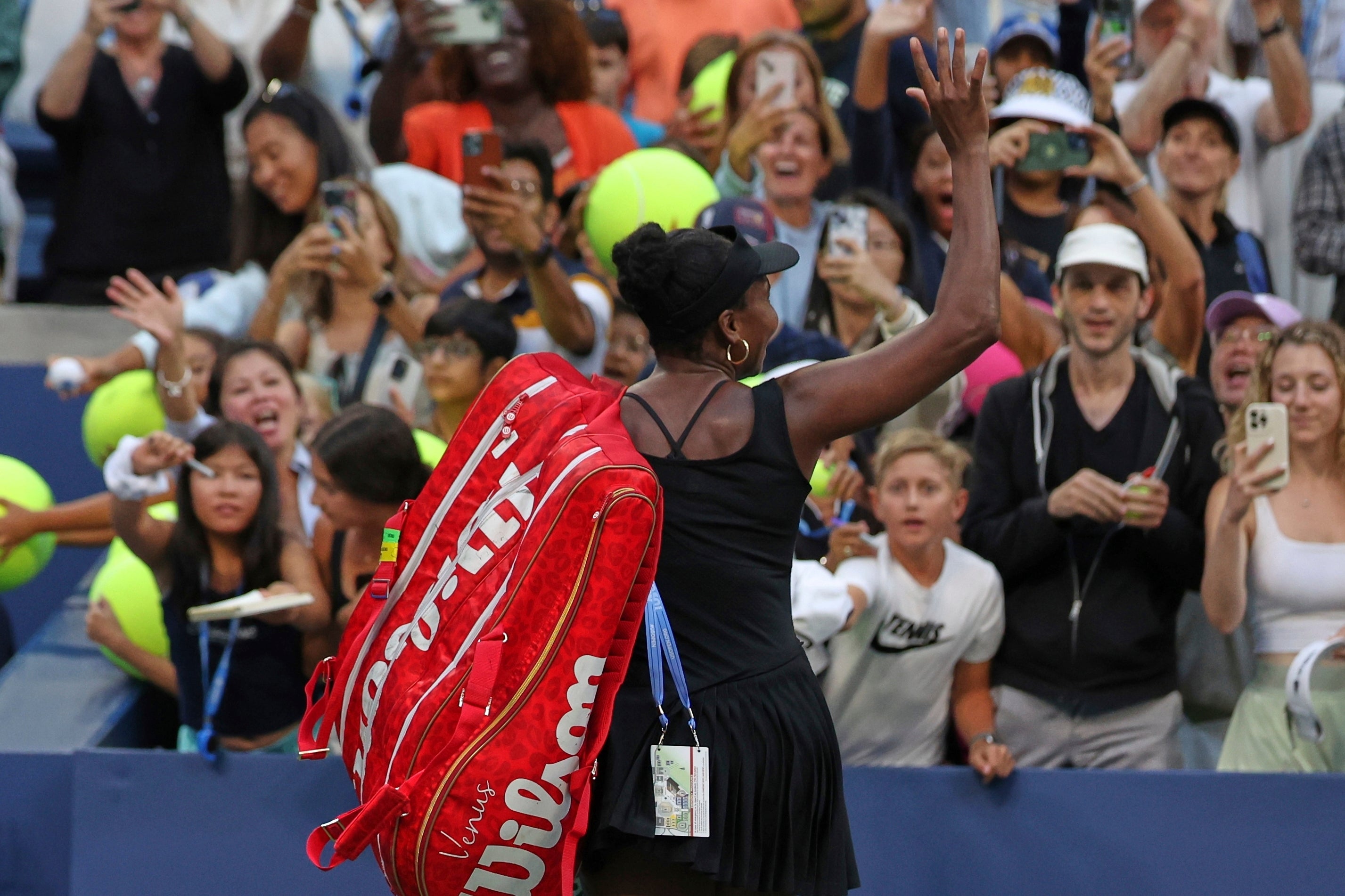 Williams waves to the crowd after defeat in the doubles