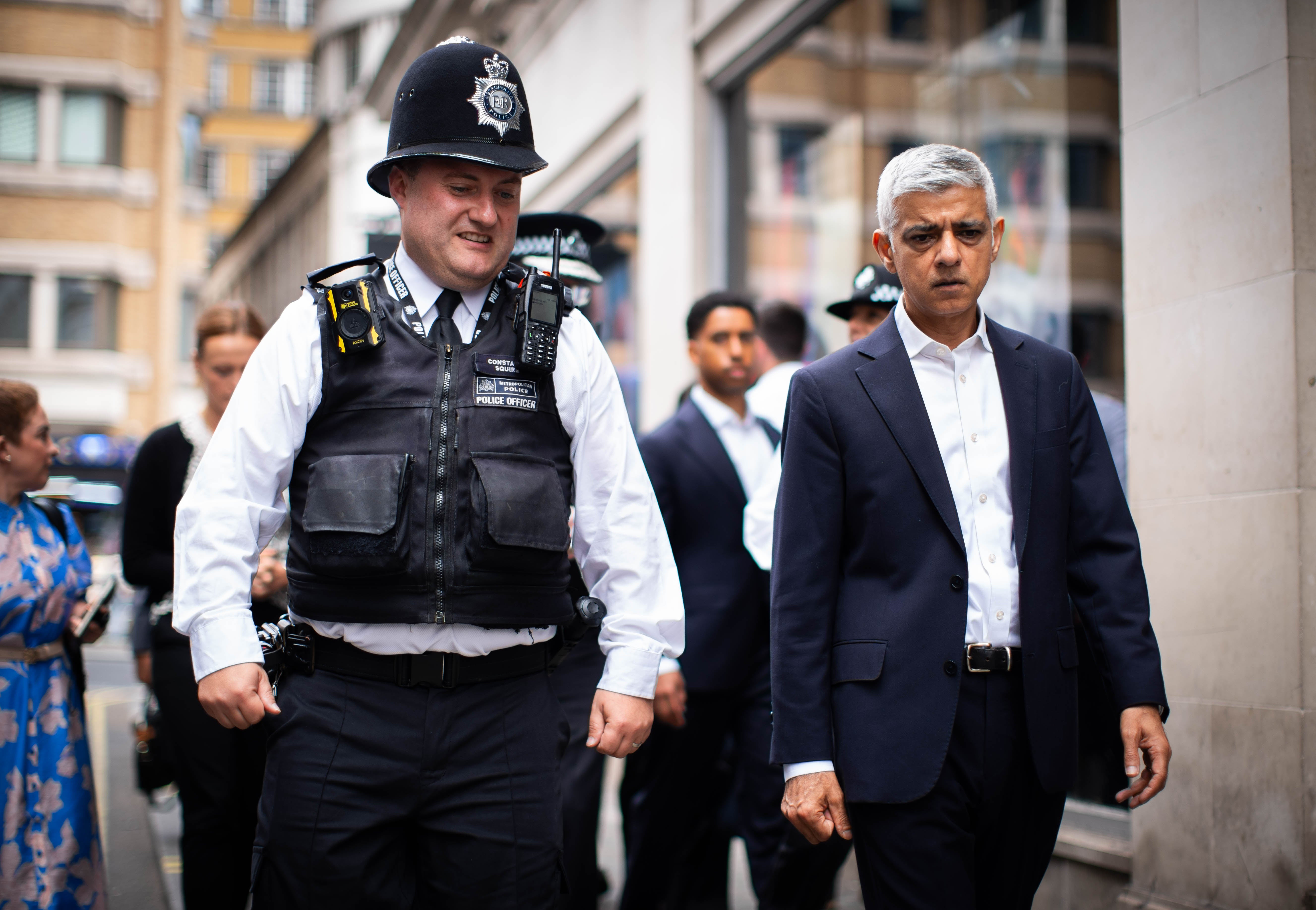 Sir Sadiq Khan speaks with police officers in the West End of London (James Manning/PA)