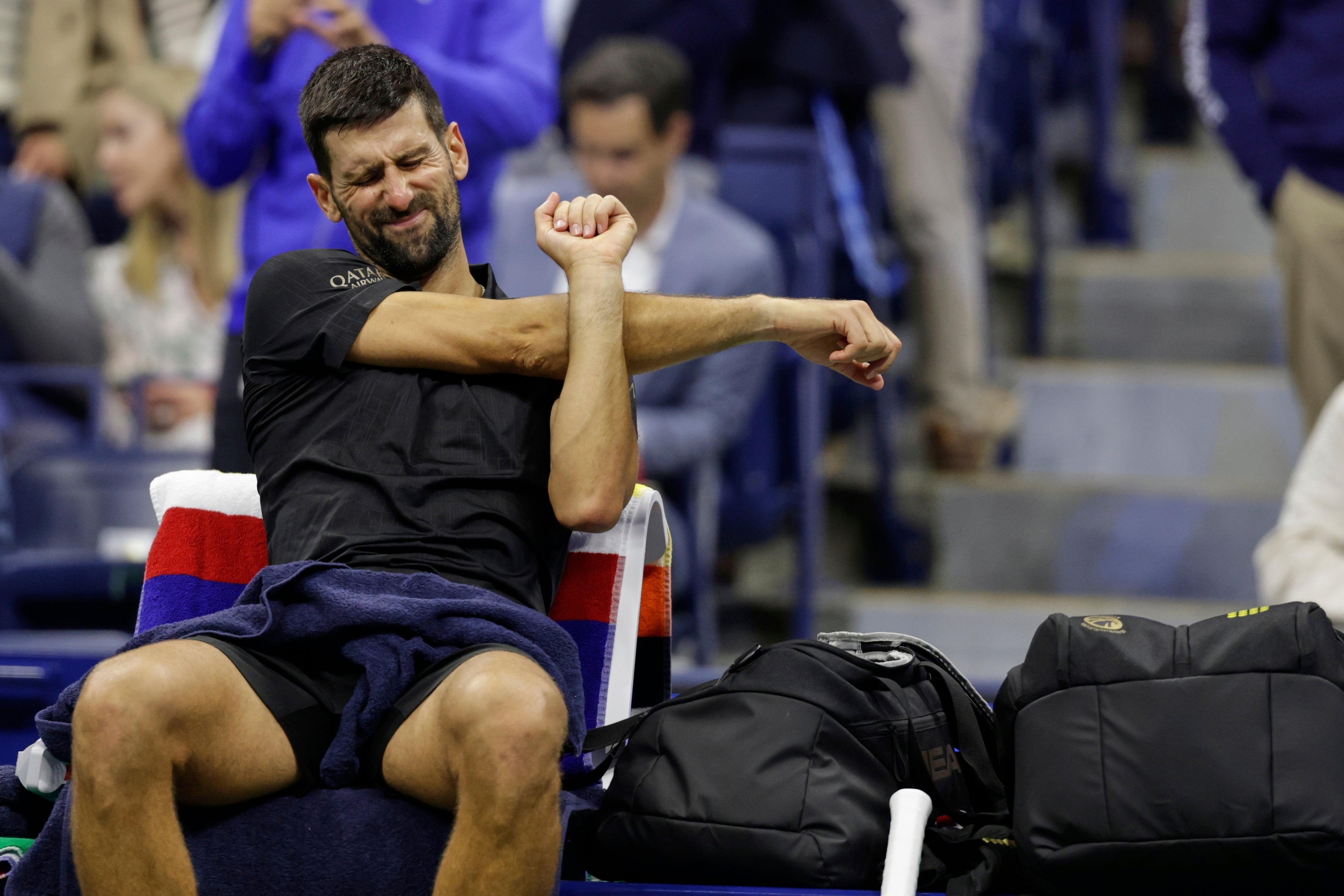 Novak Djokovic stretches (Adam Hunger/AP)