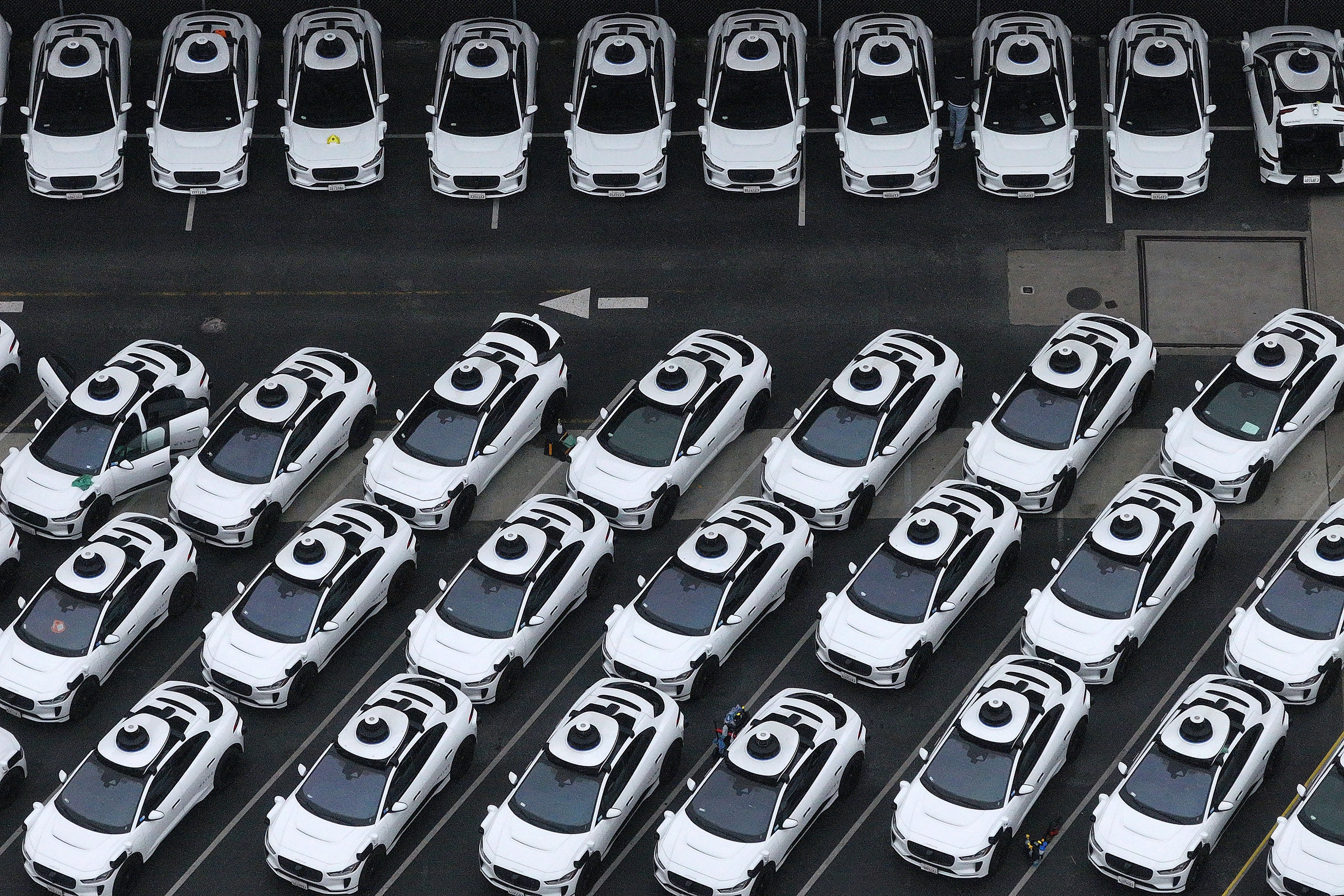 In an aerial view, Waymo cars are seen parked at a Waymo facility on 10 June, 2025 in San Francisco, California