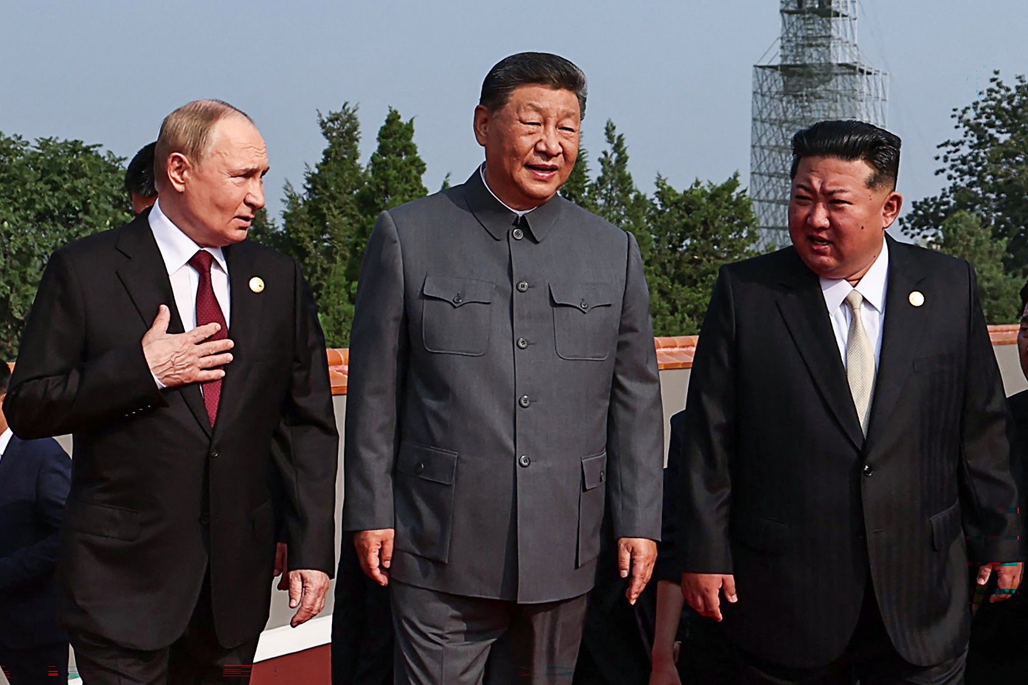 Xi walking with Vladimir Putin and Kim Jong Un before the military parade on Wednesday