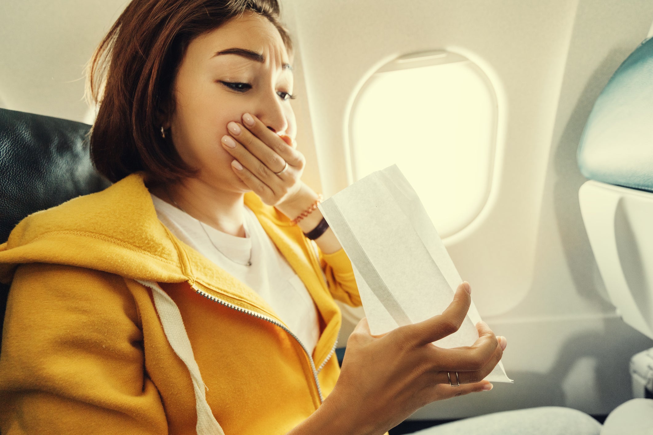 A woman suffers from motion sickness during turbulence on a plane. The researchers say their findings can likely be applied to air and sea travel, as well as cars