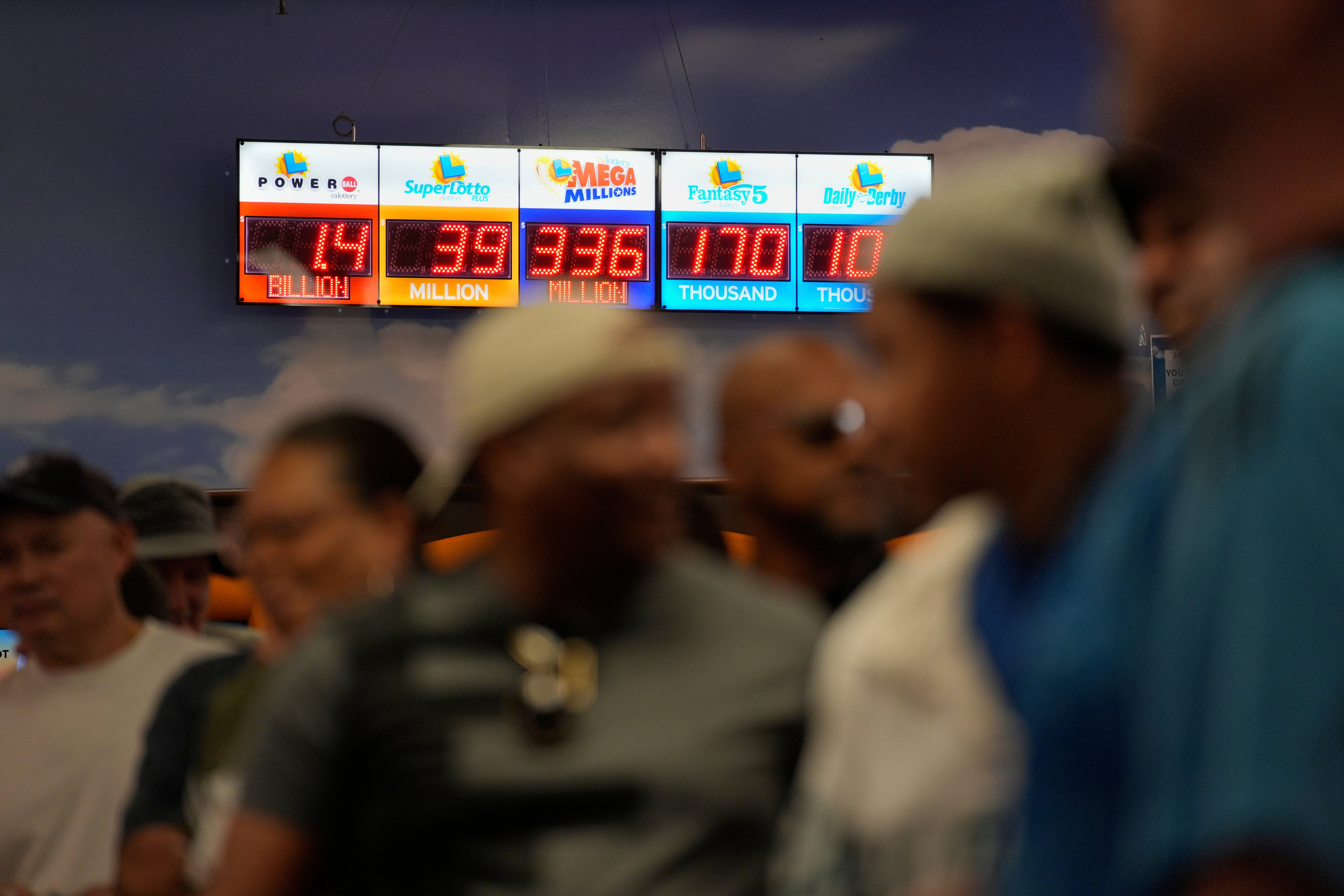 People wait in line to buy lottery tickets at the Lotto Store just inside the California border Wednesday, Sept. 3, 2025, near Primm, Nev. (AP Photo/John Locher)