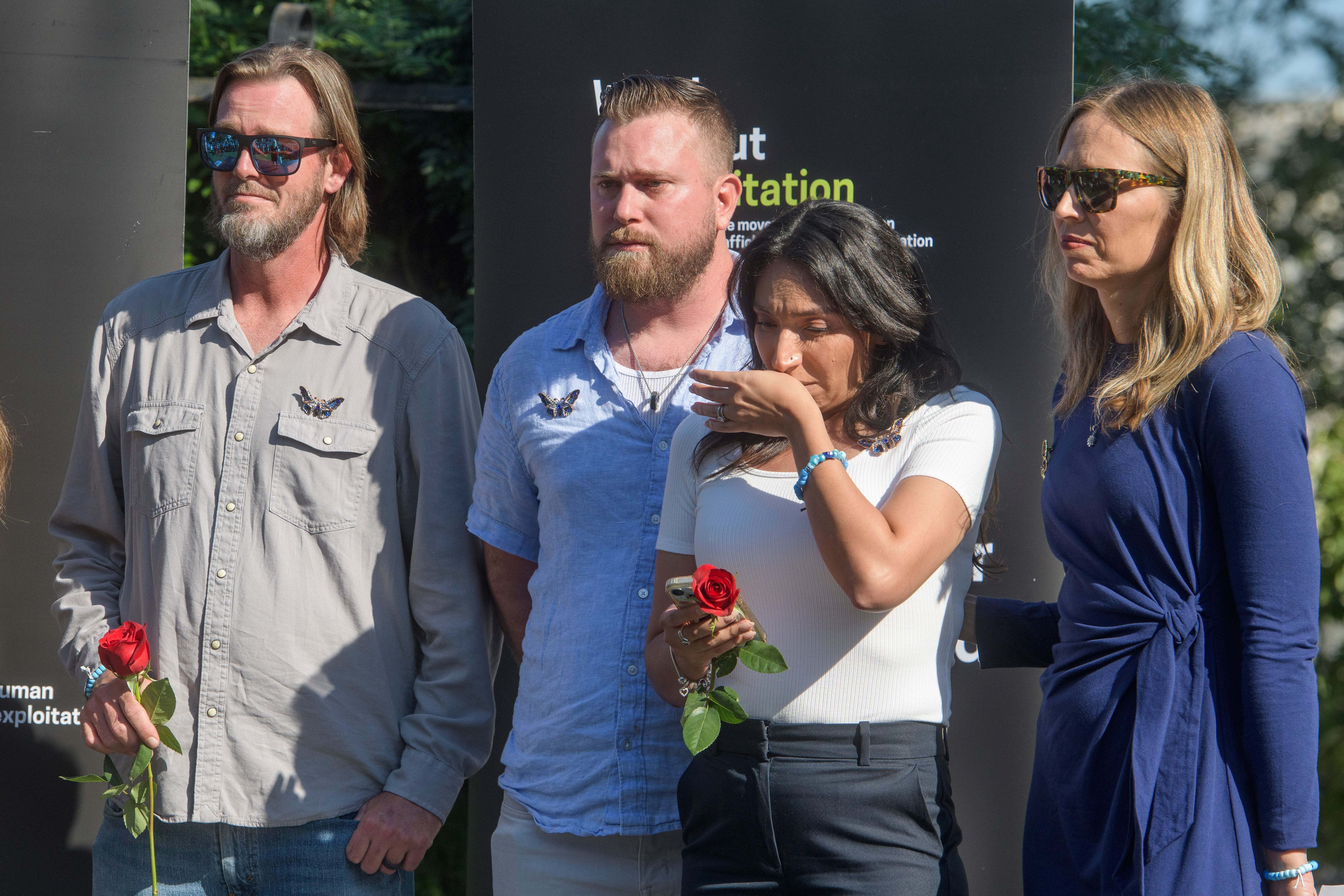 Relatives of Virginia Giuffre, Daniel Wilson, left, and Sky Roberts, second from left, Amanda Roberts, second from right, and Annie Farmer, right, listen during a Stand with Survivors Rally on Capitol Hill