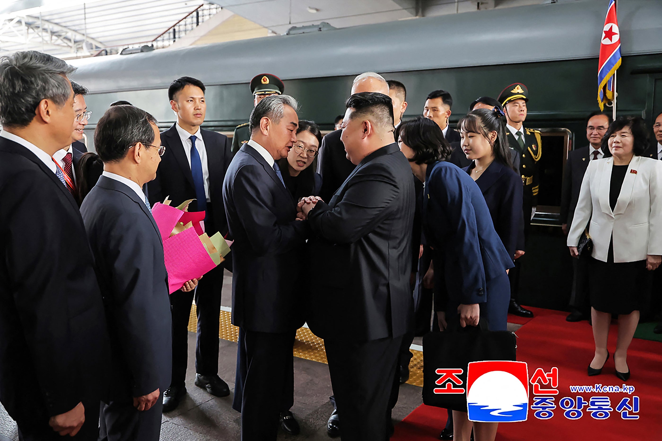 This photograph taken on 2 September 2025 and released by North Korea's official Korean Central News Agency (KCNA) via KNS shows North Korea’s leader Kim Jong Un (centre R) and his daughter Kim Ju Ae (4th R) being greeted by China’s foreign minister Wang Yi (centre L) upon their arrival at the Beijing Railway Station in Beijing
