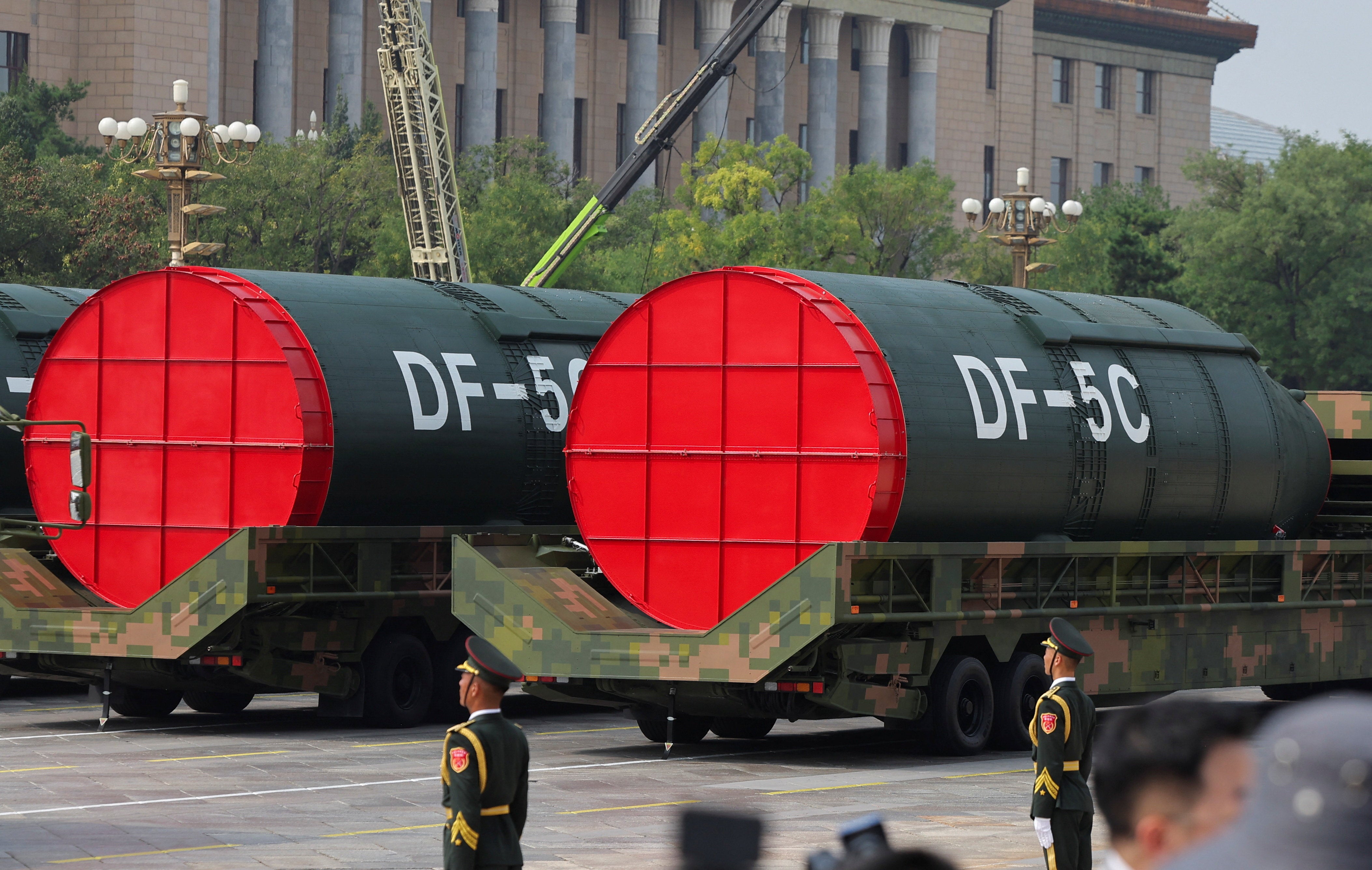 Members of the People's Liberation Army stand as the strategic strike group displays DF-5C nuclear missiles during a military parade