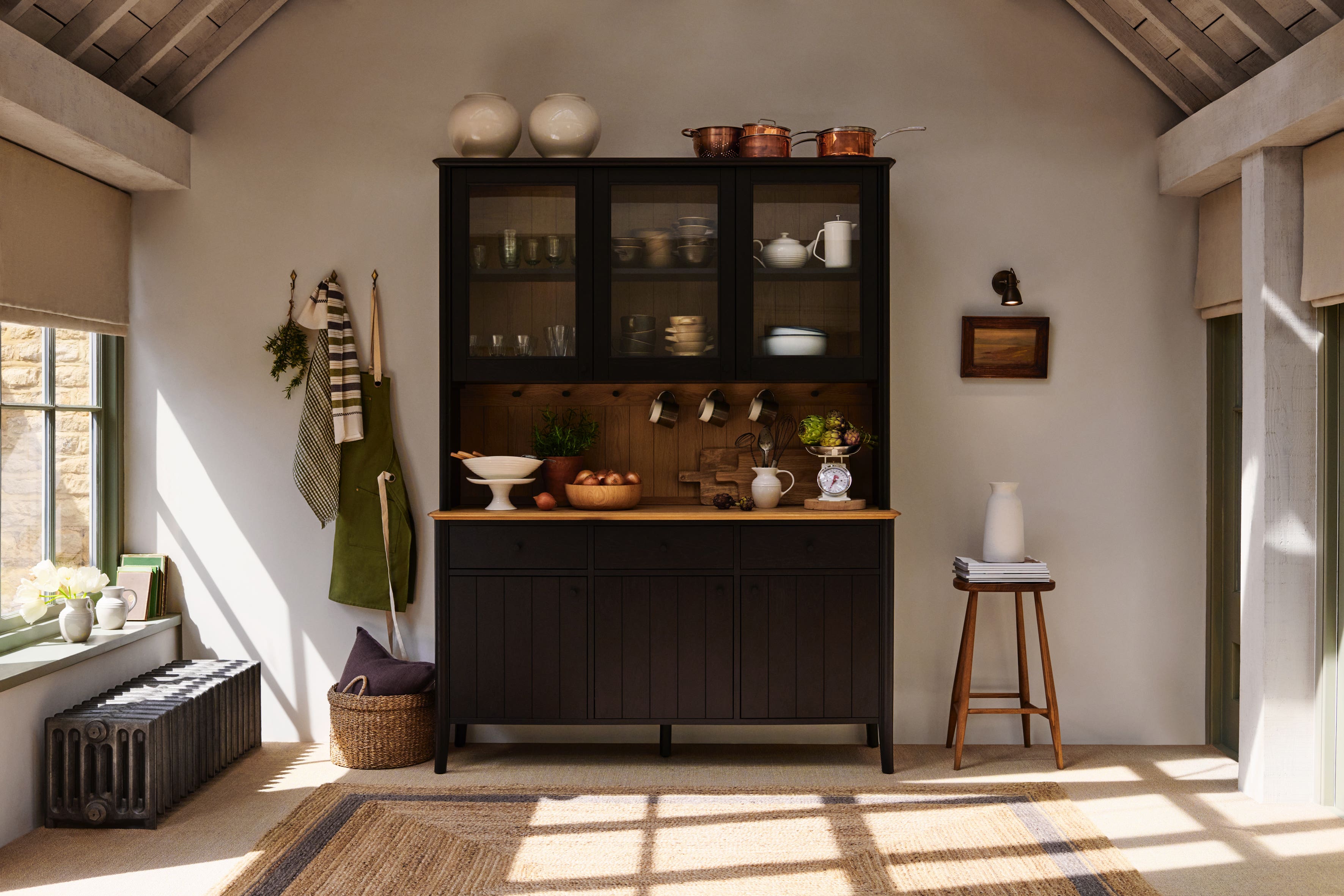 Earthy browns, leather and dark timber décor are making their mark (John Lewis/PA)