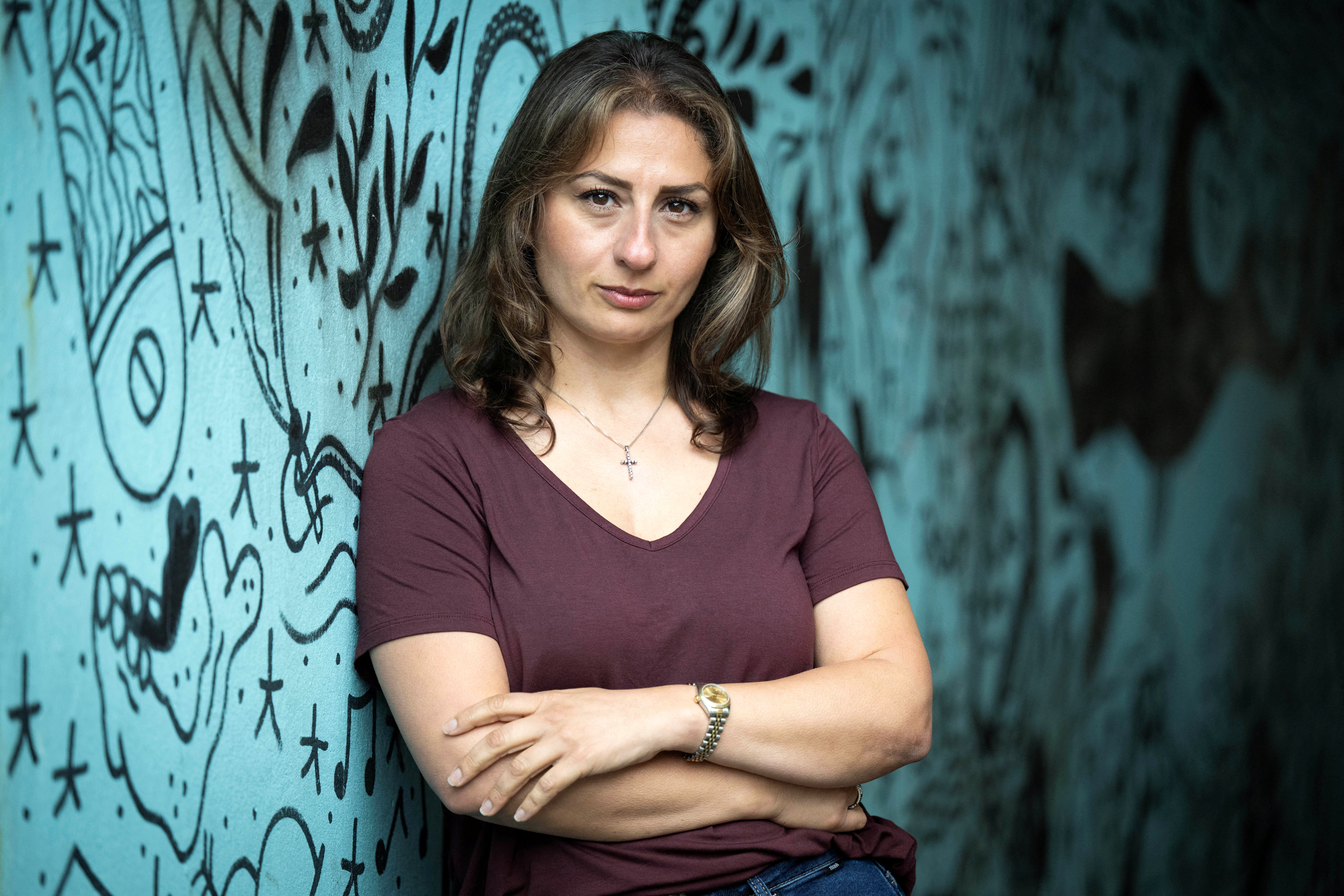 Brewmaster Madees Khoury poses for a portrait near a mural celebrating a Palestinian lager launched by Taybeh Brewing Co., a microbrewery based in the Israeli-occupied West Bank, with the help of Scottish brewer Brewgooder, in Glasgow, Scotland, Britain, September 3, 2025. REUTERS/Lesley Martin