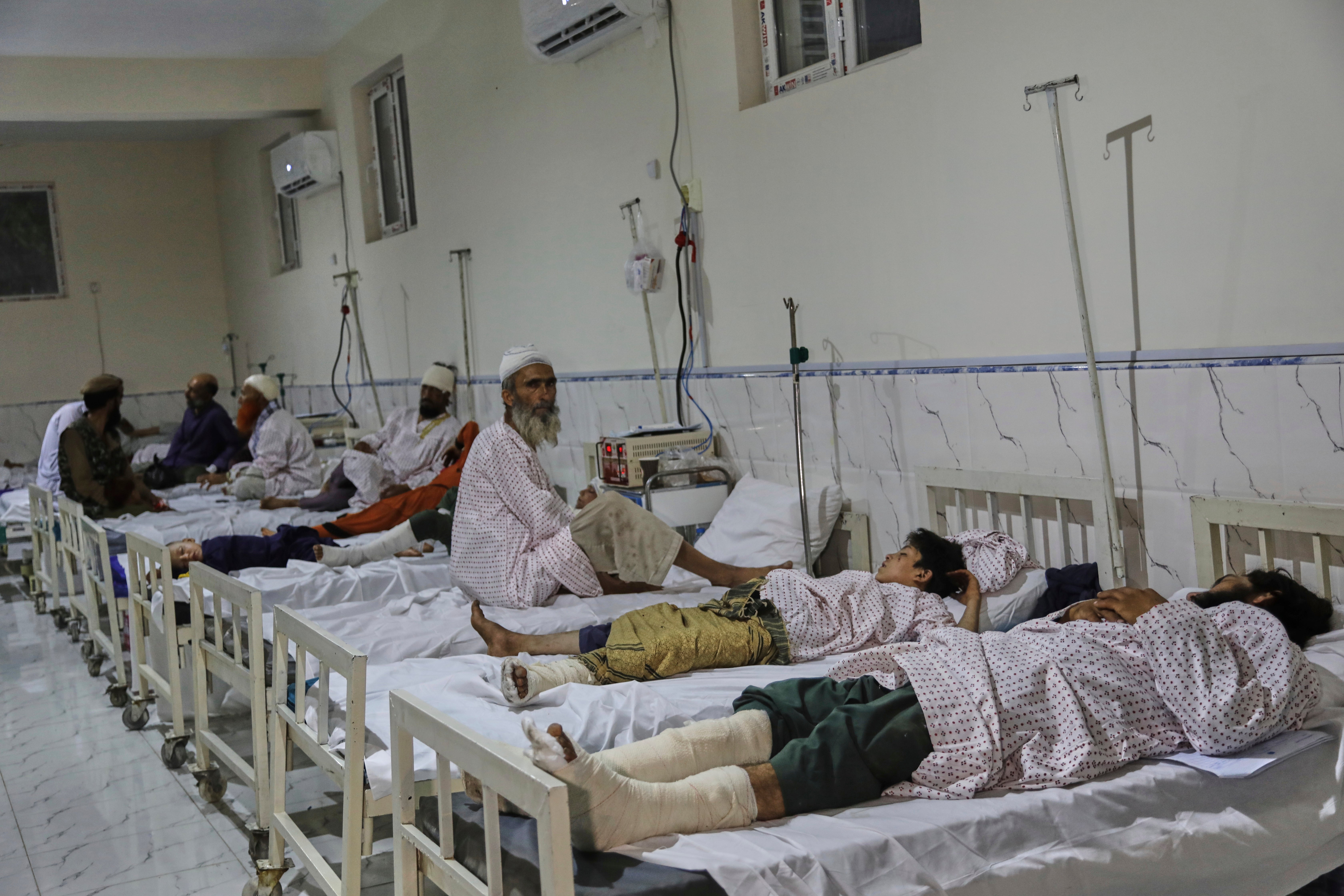 Afghans injured in a powerful earthquake that struck eastern Afghanistan on Sunday, lie on beds at Nangarhar Regional Hospital in Jalalabad, Afghanistan