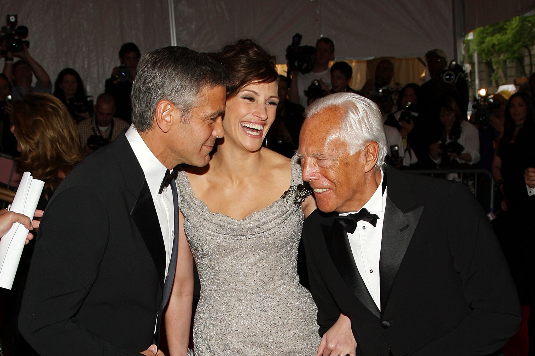 Actors George Clooney and Julia Roberts with designer Giorgio Armani, arriving at the Metropolitan Museum of Art Costume Institute Gala