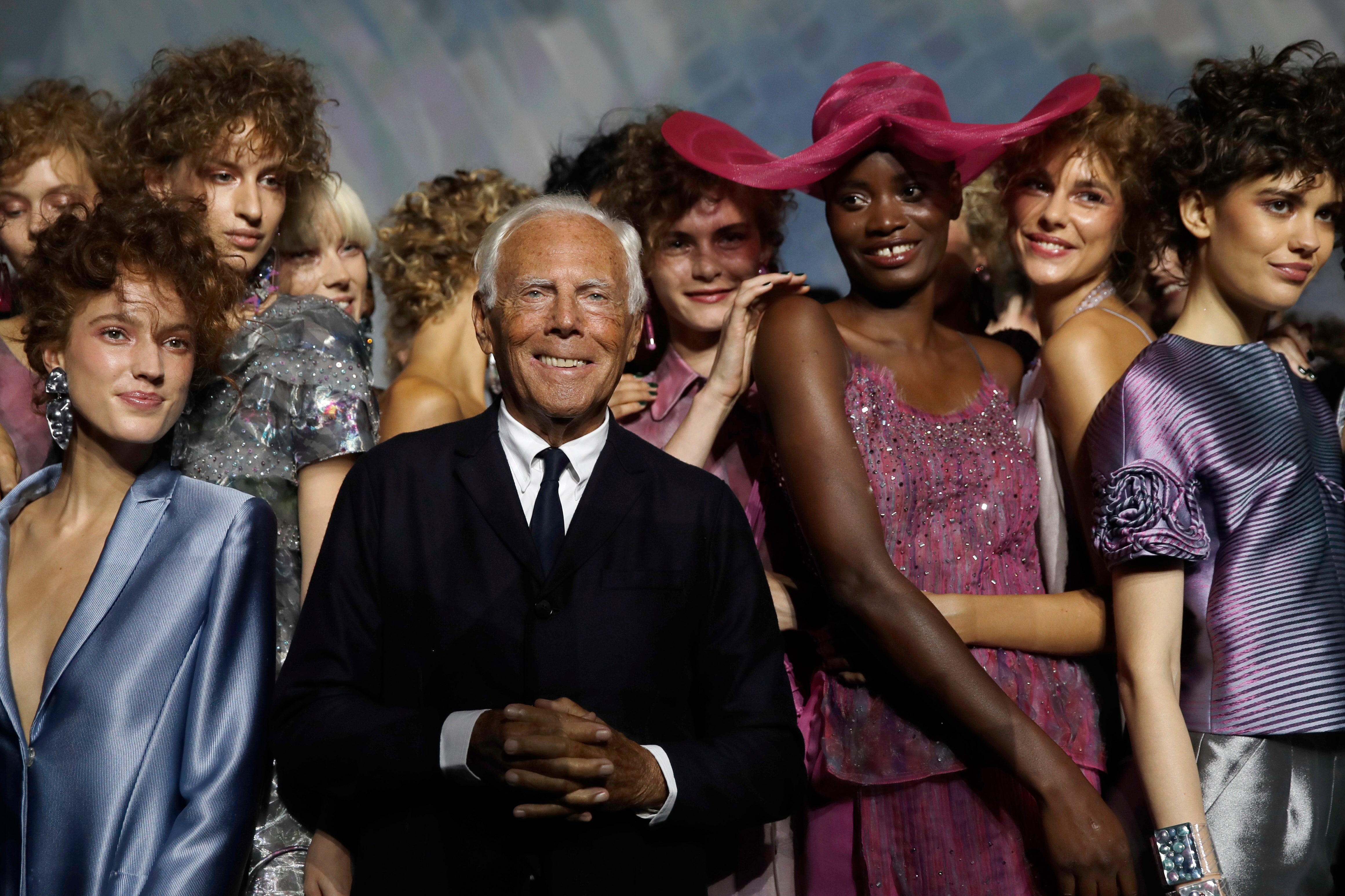 Designer Giorgio Armani, centre, poses with models at the end of his women’s 2019 spring-summer collection