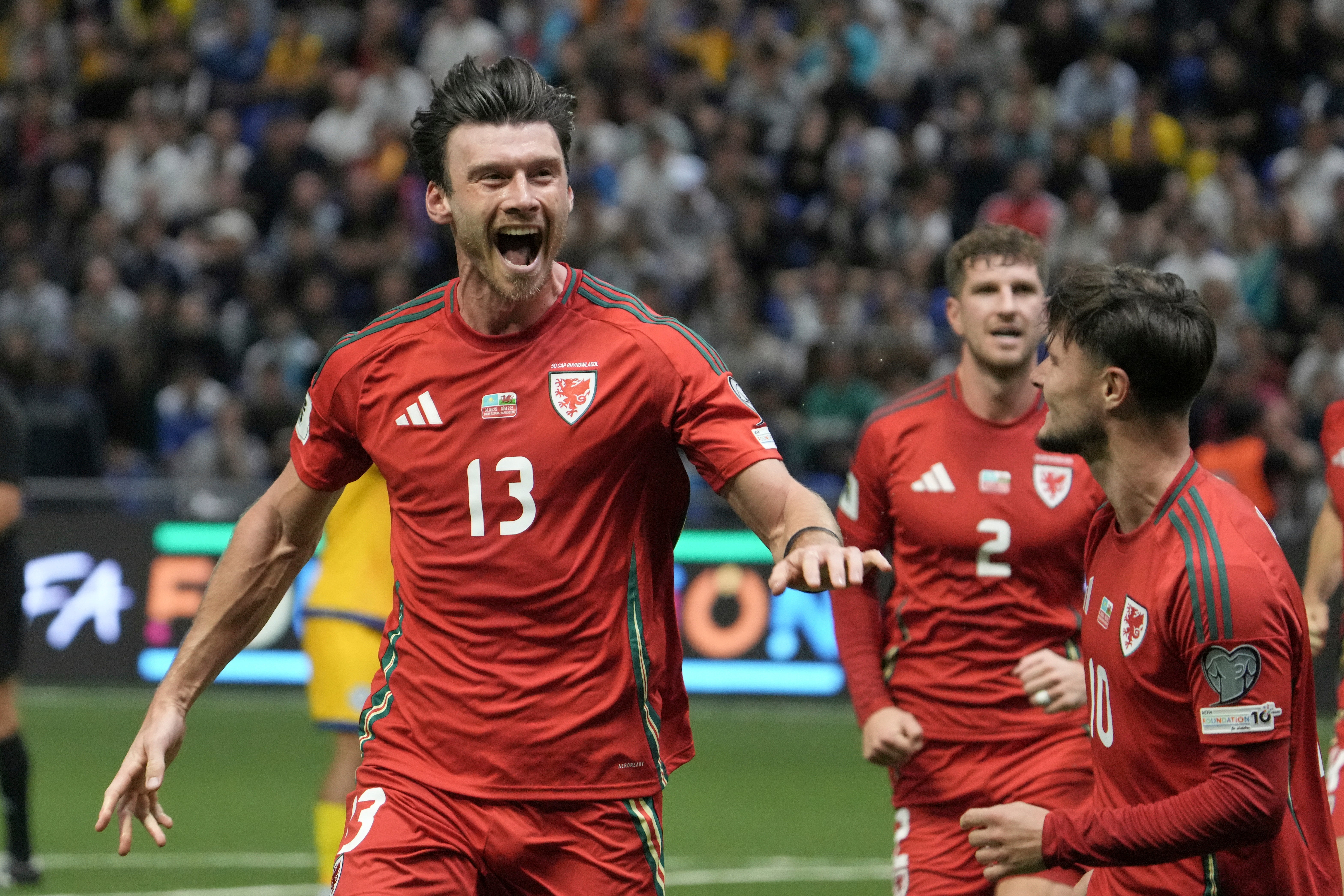 Moore’s 15th international goal drew him level with the great John Charles (Turar Kazangapov/AP)