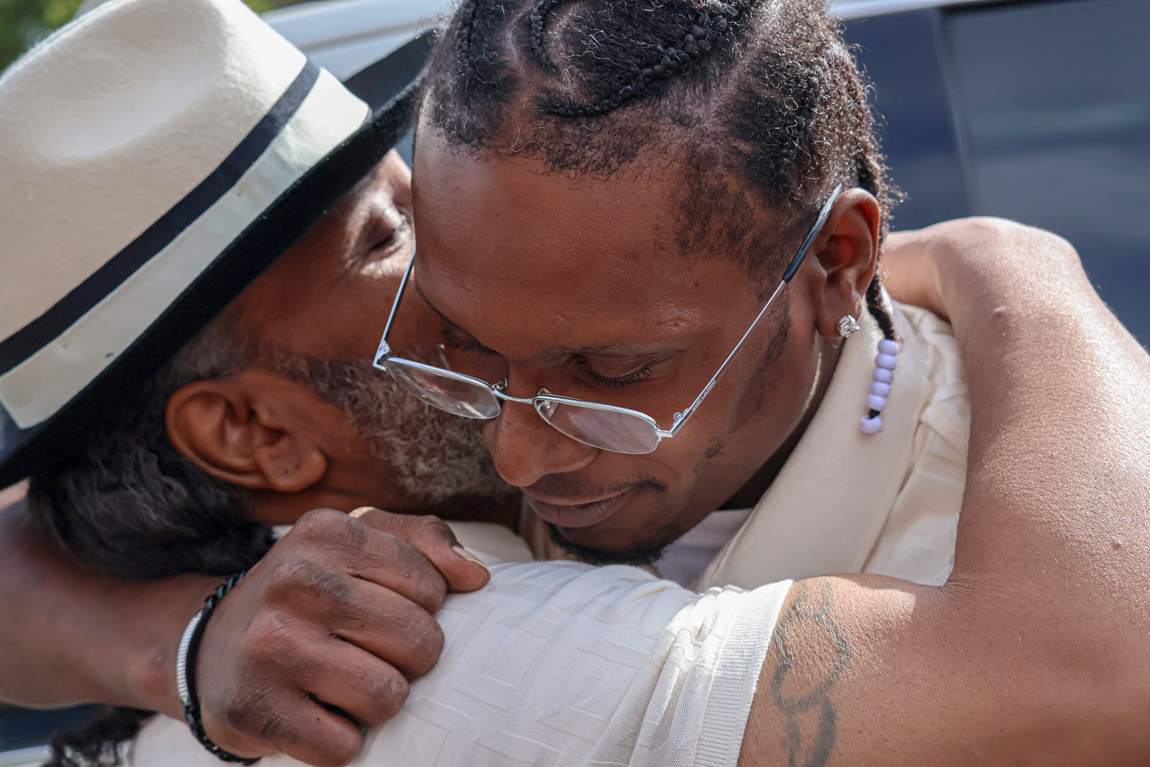 After a judge found him innocent of a 1998 murder, Bryan Hooper Sr., left, embraces his son Bryan Hooper Jr. outside Stillwater Prison on Thursday, Sept. 4, 2025 in Bayport, Minn. (Matt Sepic/Minnesota Public Radio via AP)