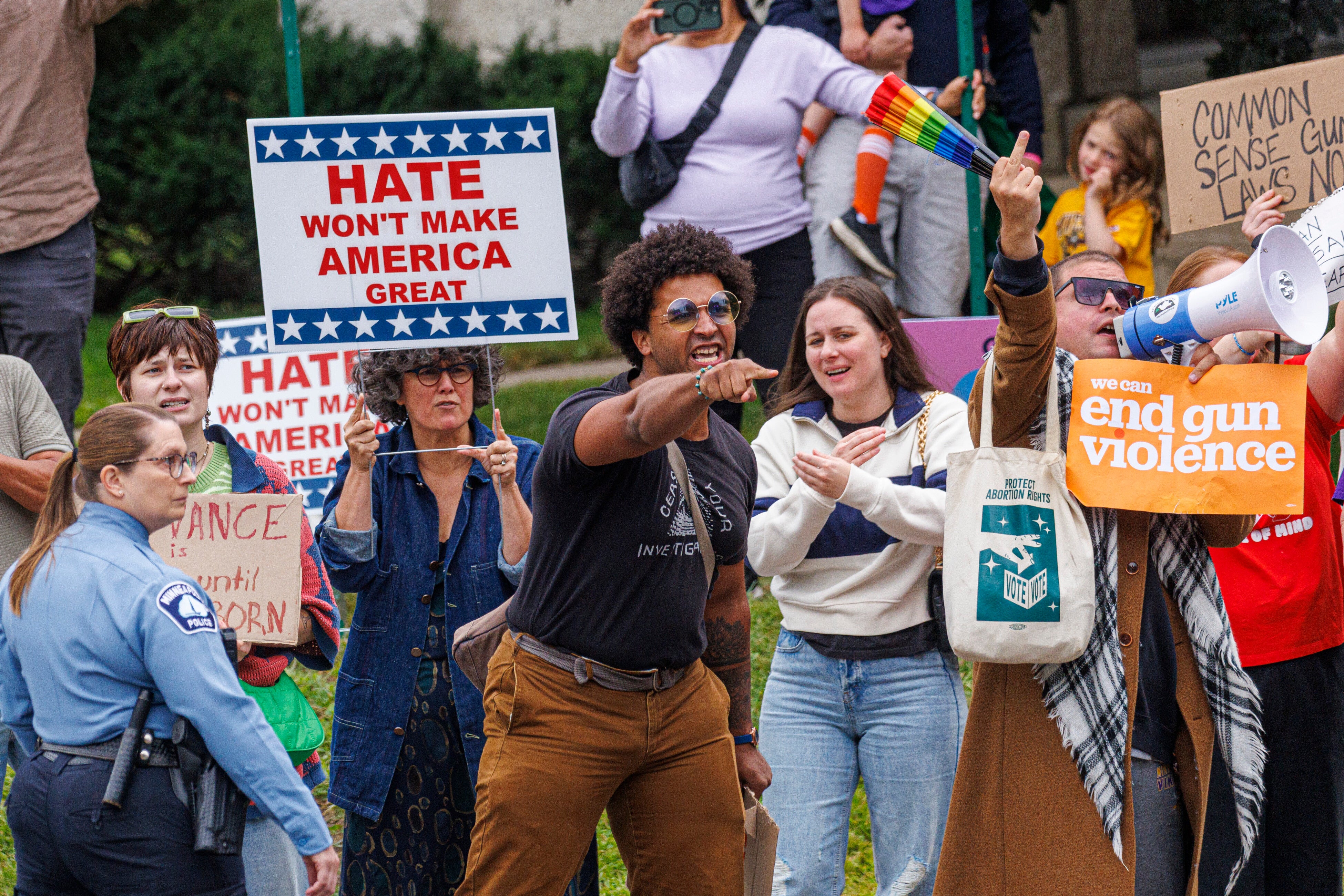 Protesters gather to demonstrate against gun violence in Minneapolis on Wednesday during Vance's visit to Annunciation Catholic Church