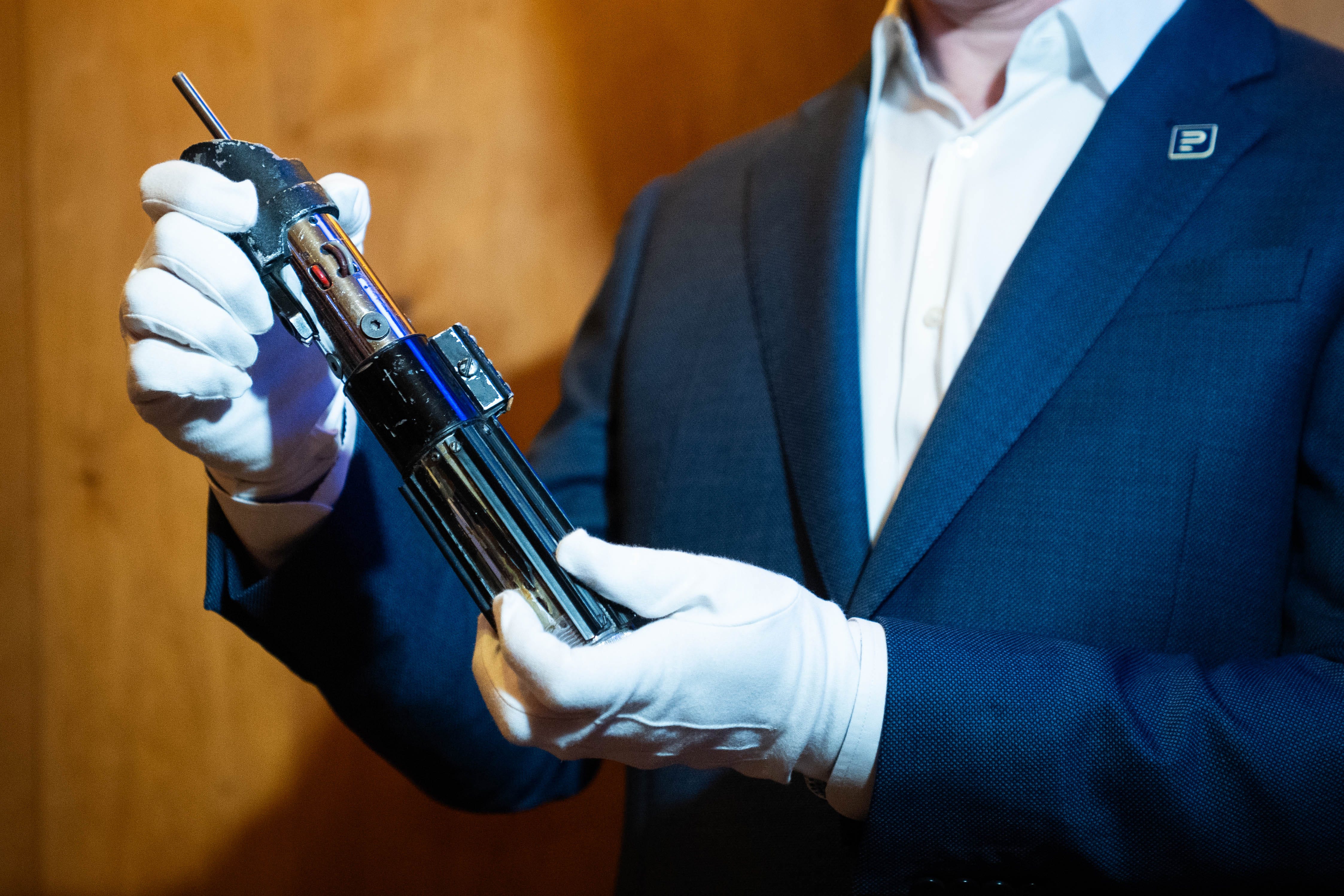 Darth Vader’s duelling lightsaber was sold for £2.7 million (James Manning/PA)