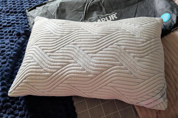One of the best pillows, a Tempur cloud cooltouch pillow, on a bed