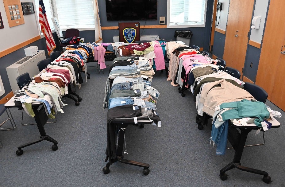 Police display the items allegedly taken from a Massachusetts TJ Maxx by two shoplifters.