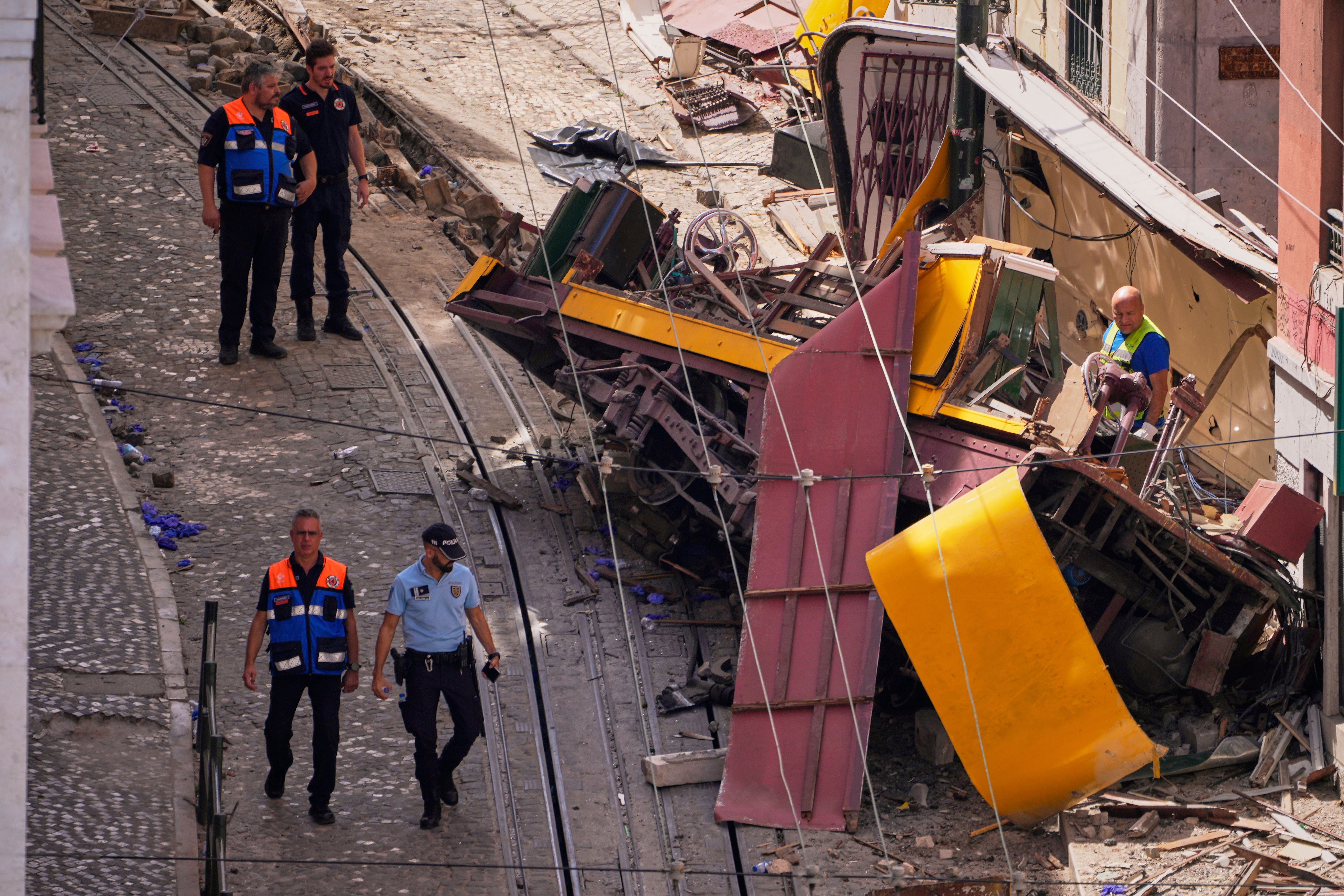 Police officers inspect the site of the crash (Armando Franca/AP)
