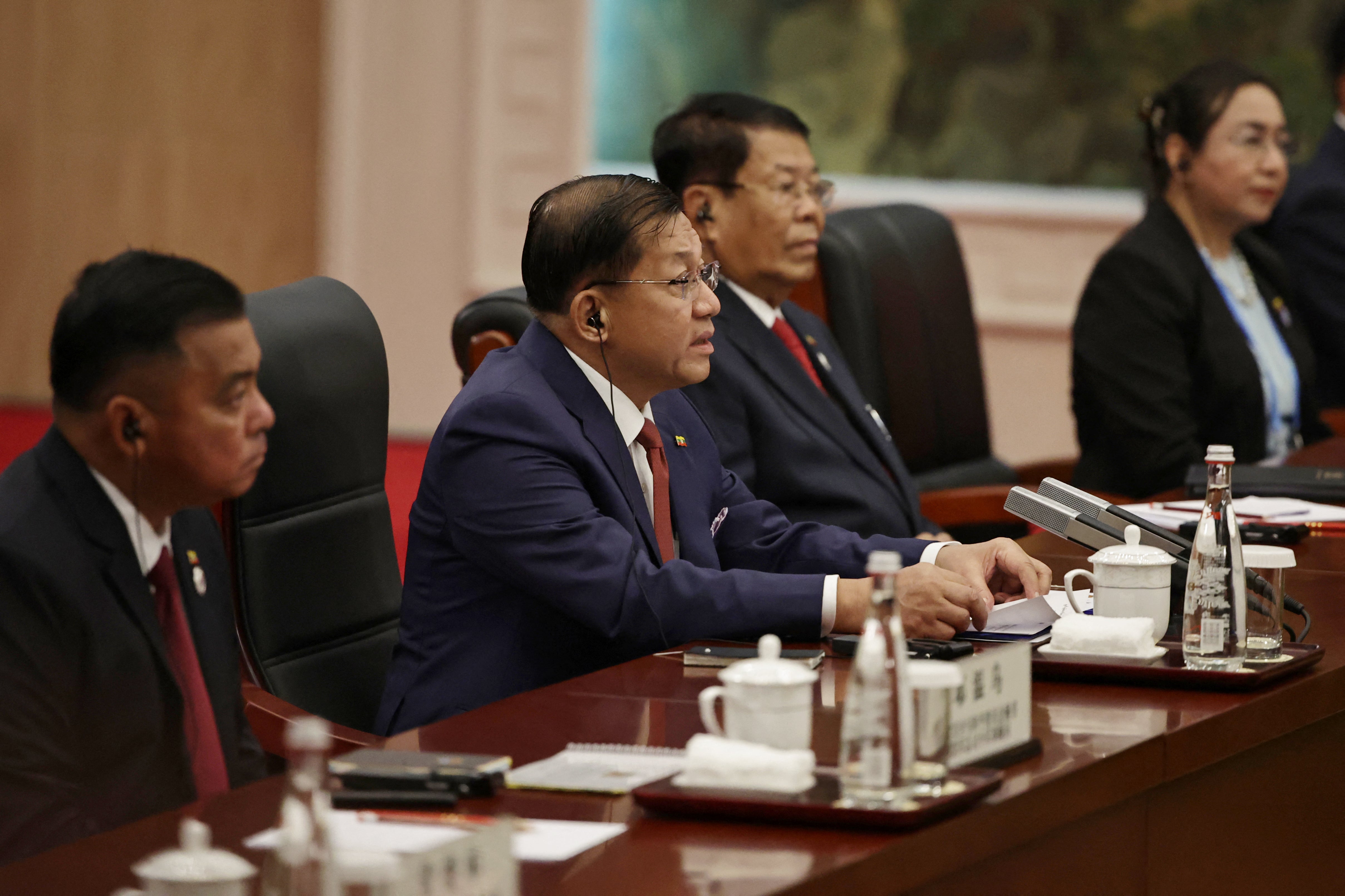 Myanmar's junta chief Min Aung Hlaing (C) speaks during a bilateral meeting with China's President Xi Jinping ahead of the Shanghai Cooperation Organisation (SCO) Summit