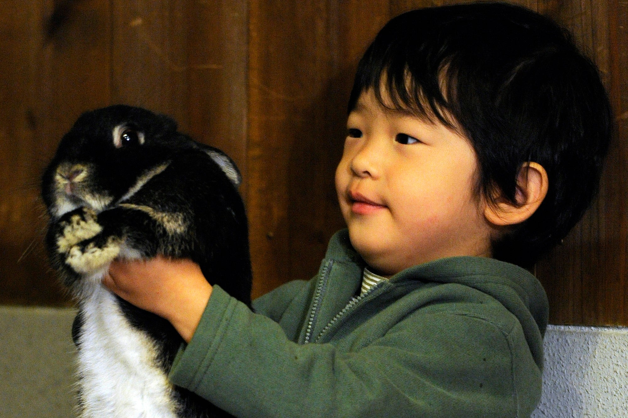 Japan's Prince Hisahito, 3, smiles as he holds a rabbit during his visit to Ueno Zoo in Tokyo, Japan, with his parents Prince Akishino and Princess Kiko in 2009