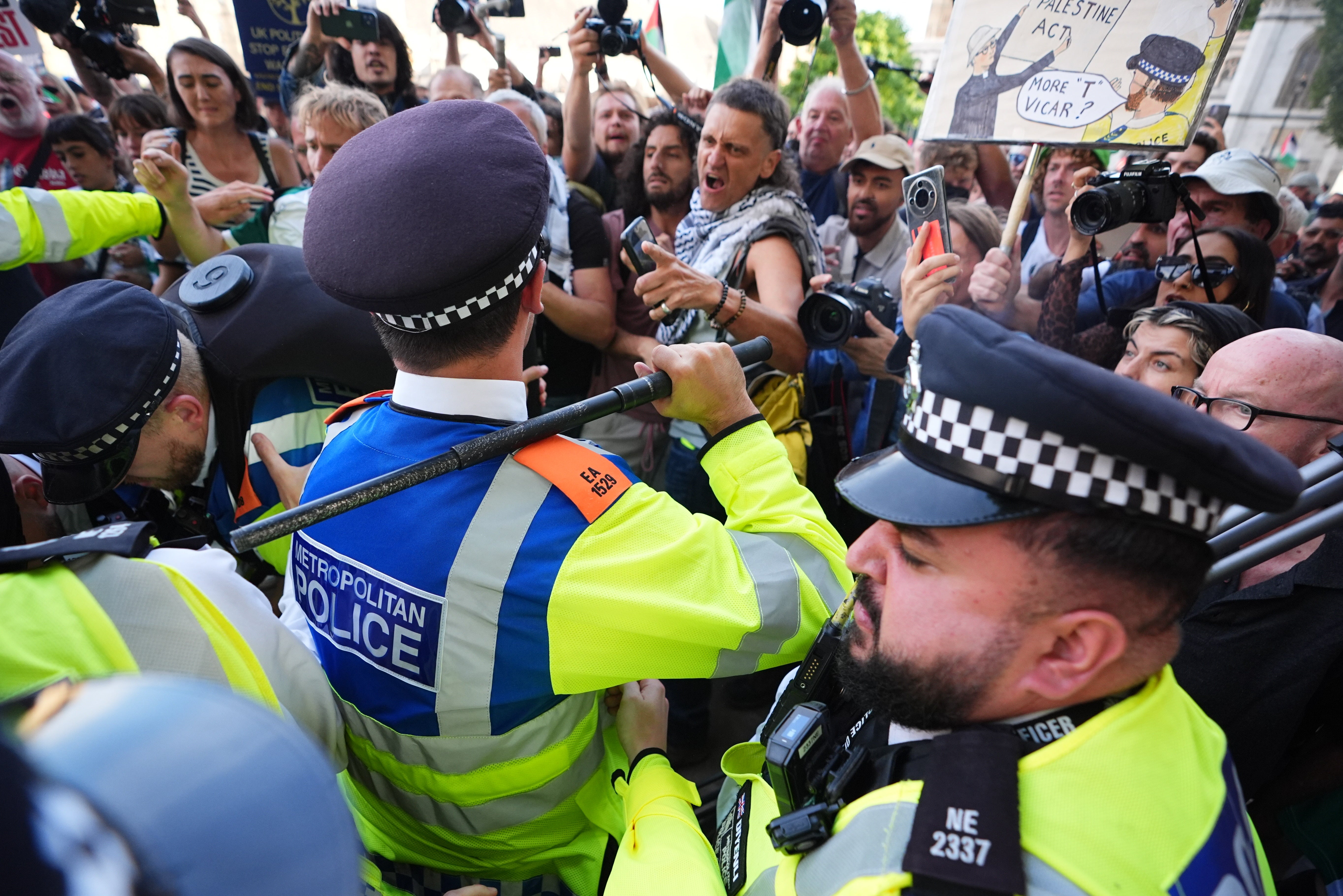 Officers with their batons drawn during scuffles with protesters
