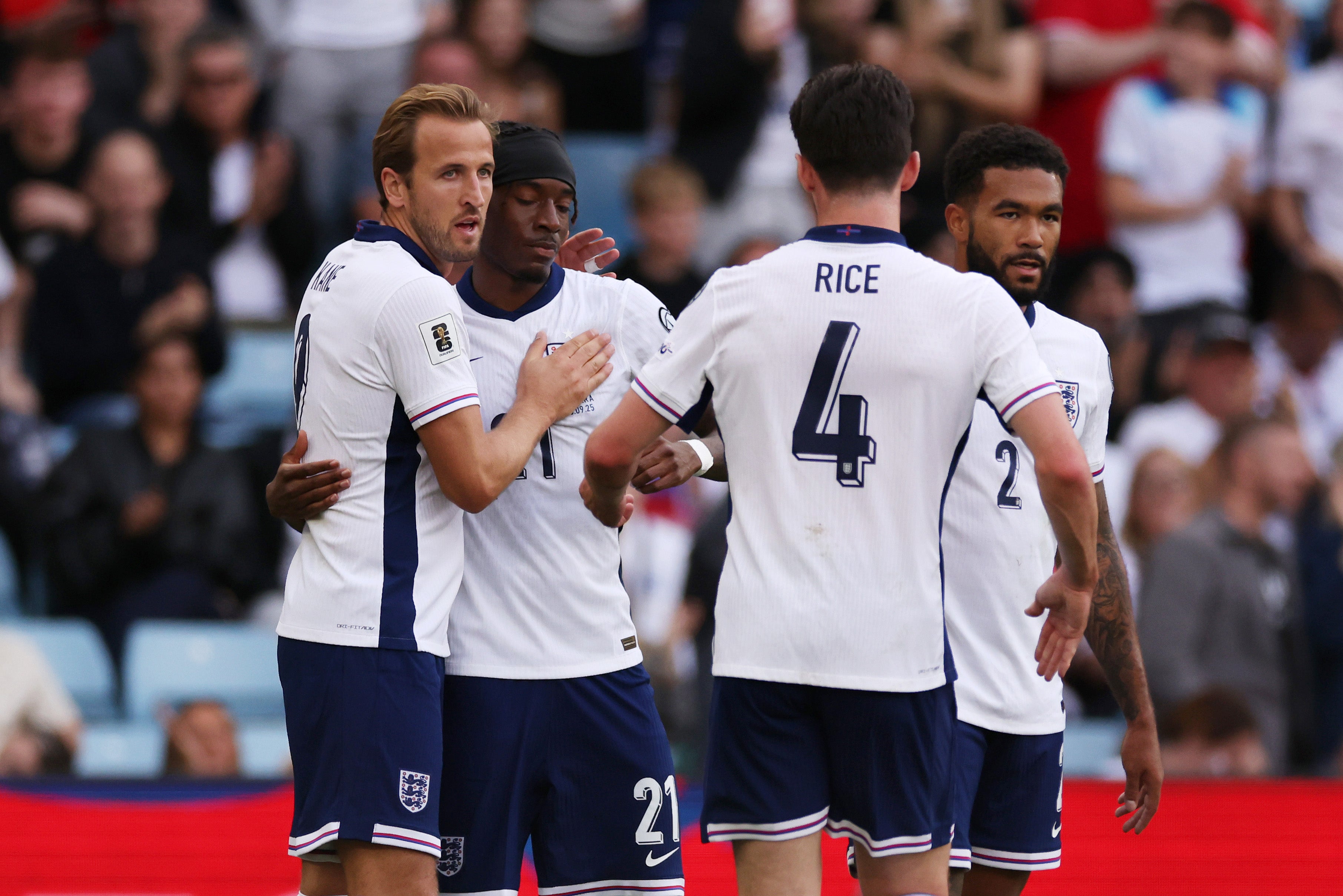 Harry Kane and Noni Madueke celebrate their side's first goal, an own goal by Christian Garcia of Andorra