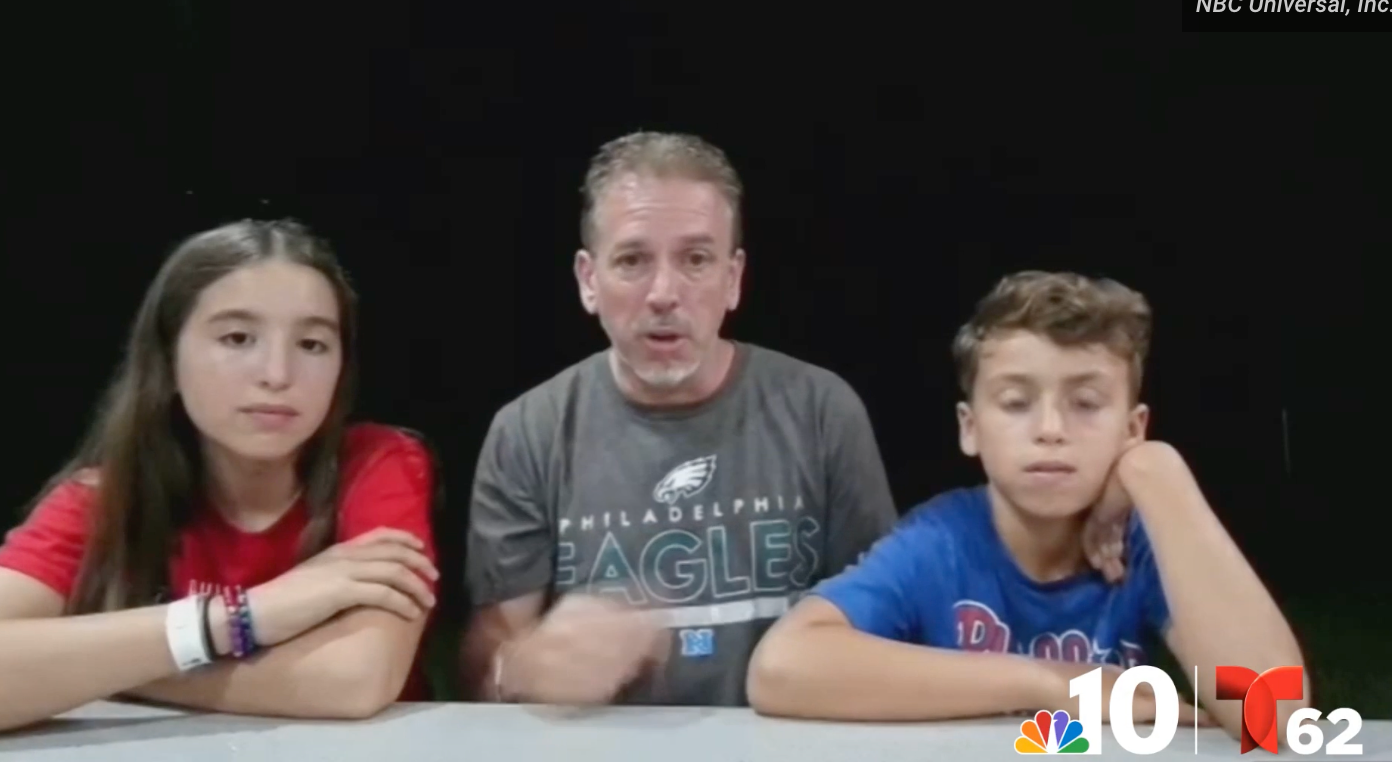 Dan Feltwell, middle, appears with his children to discussing the viral video of him handing over a home run ball he snagged for his son to an angry Phillies fan who confronted him in the stands