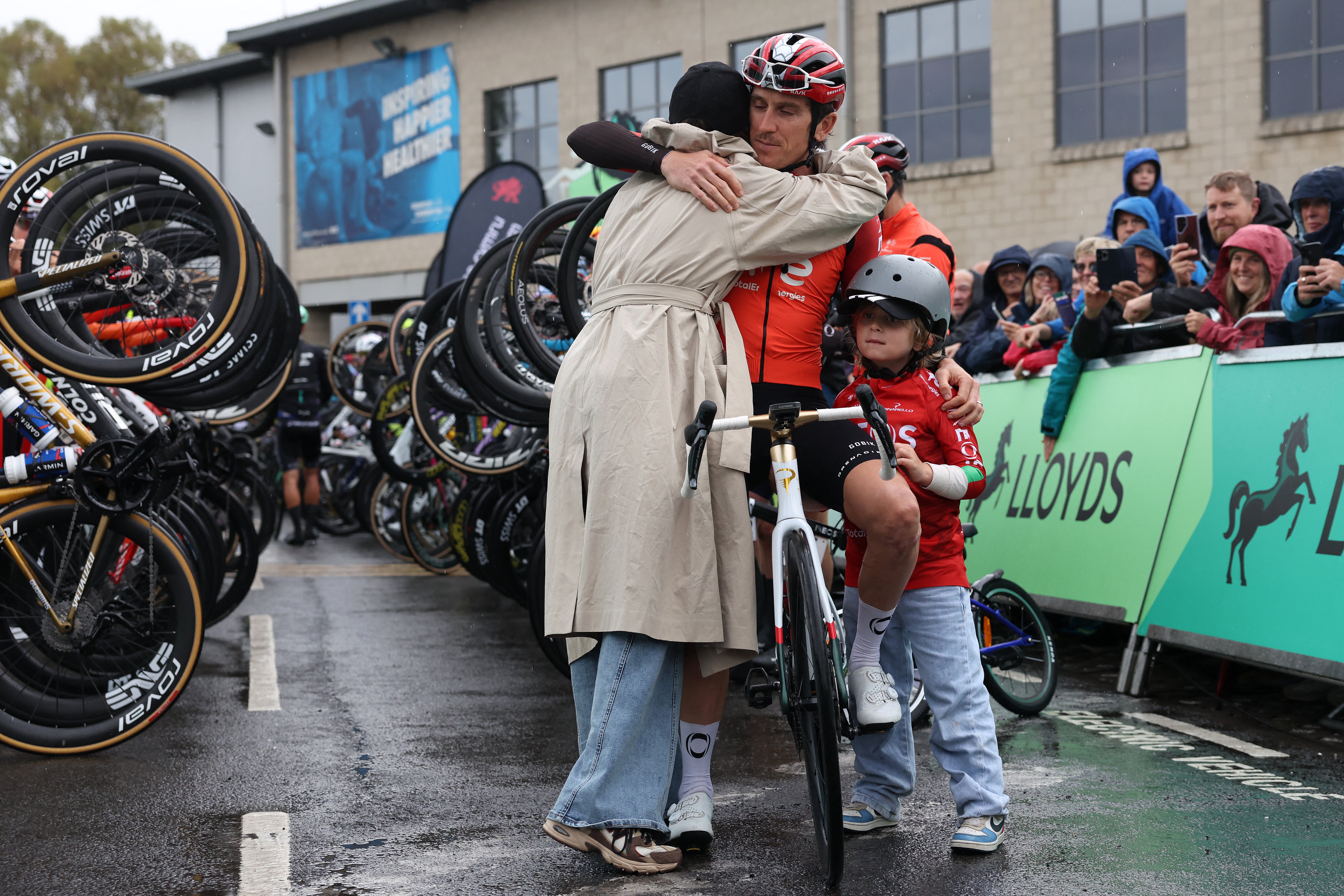 Geraint Thomas is hugged by his wife Sara and their son Macs