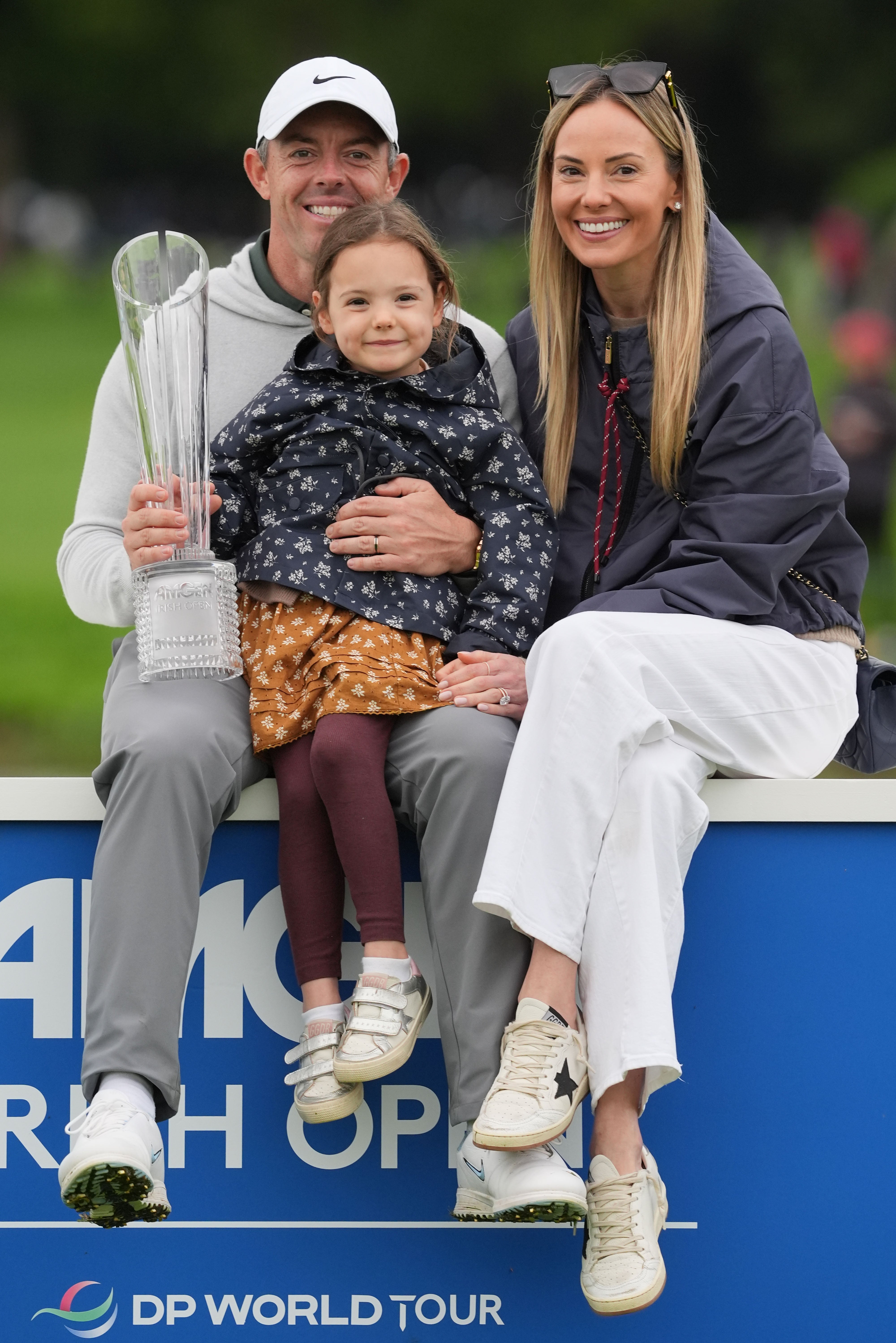 McIlroy, with his wife Erica Stoll and their daughter Poppy, celebrates after victory