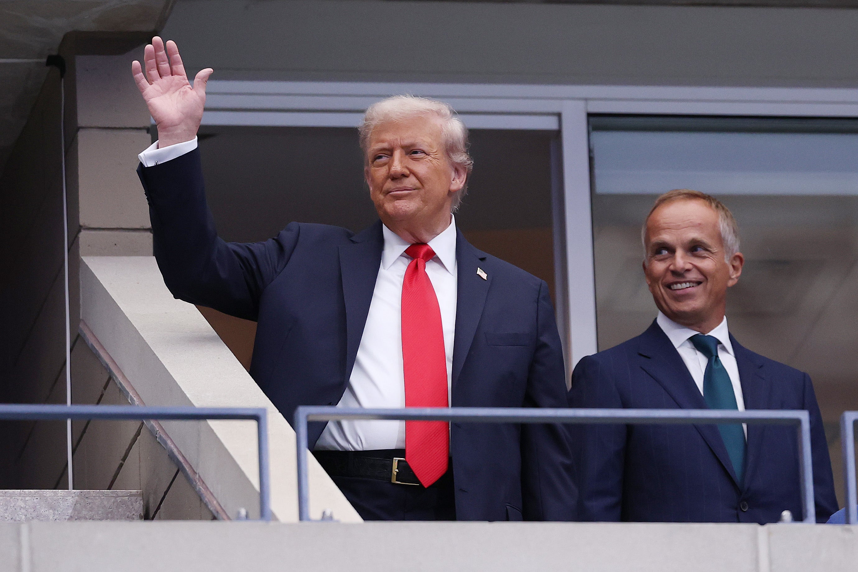 Trump waves after arriving at the Arthur Ashe Stadium