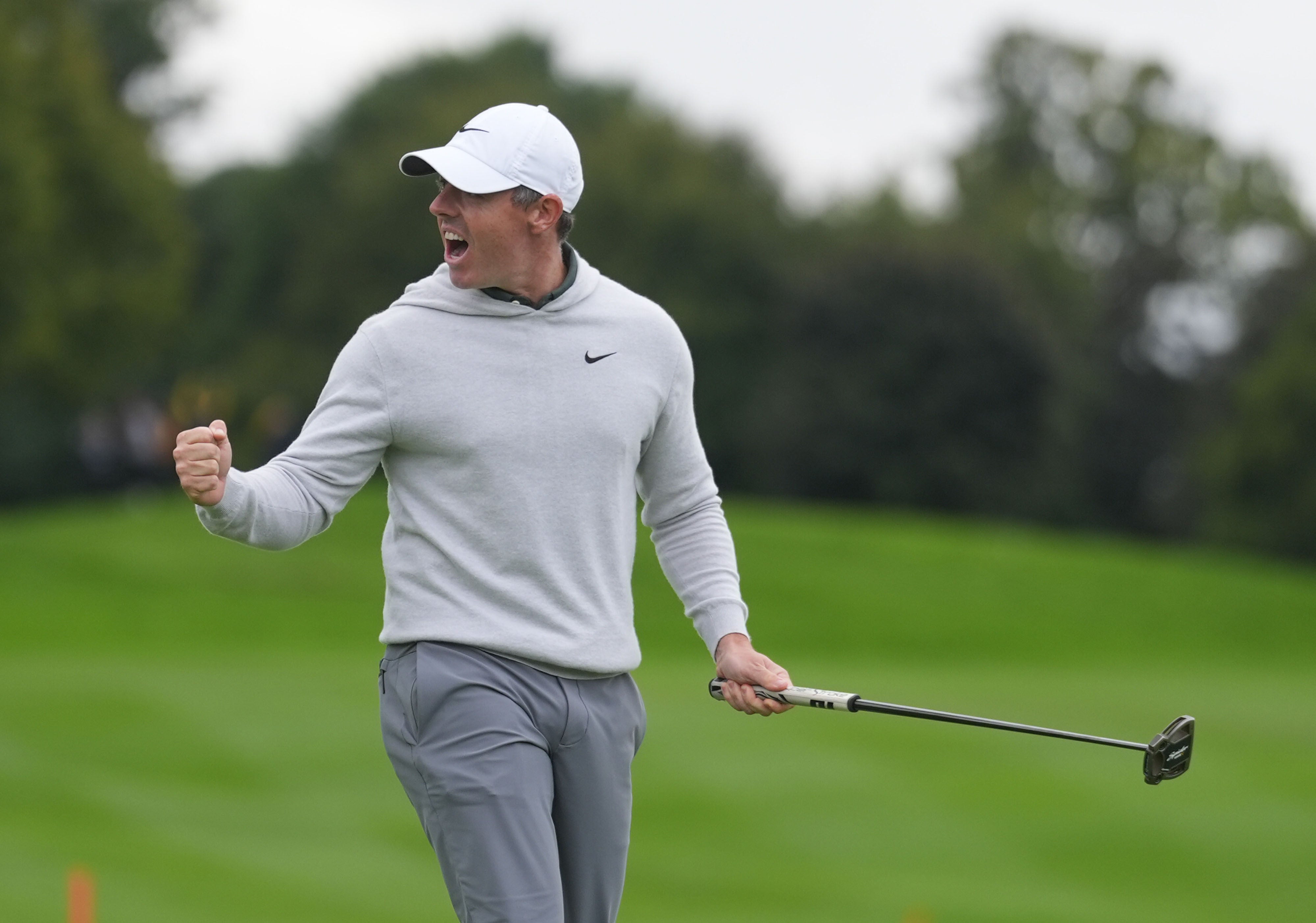 Rory McIlroy celebrates after his eagle putt forced a play-off