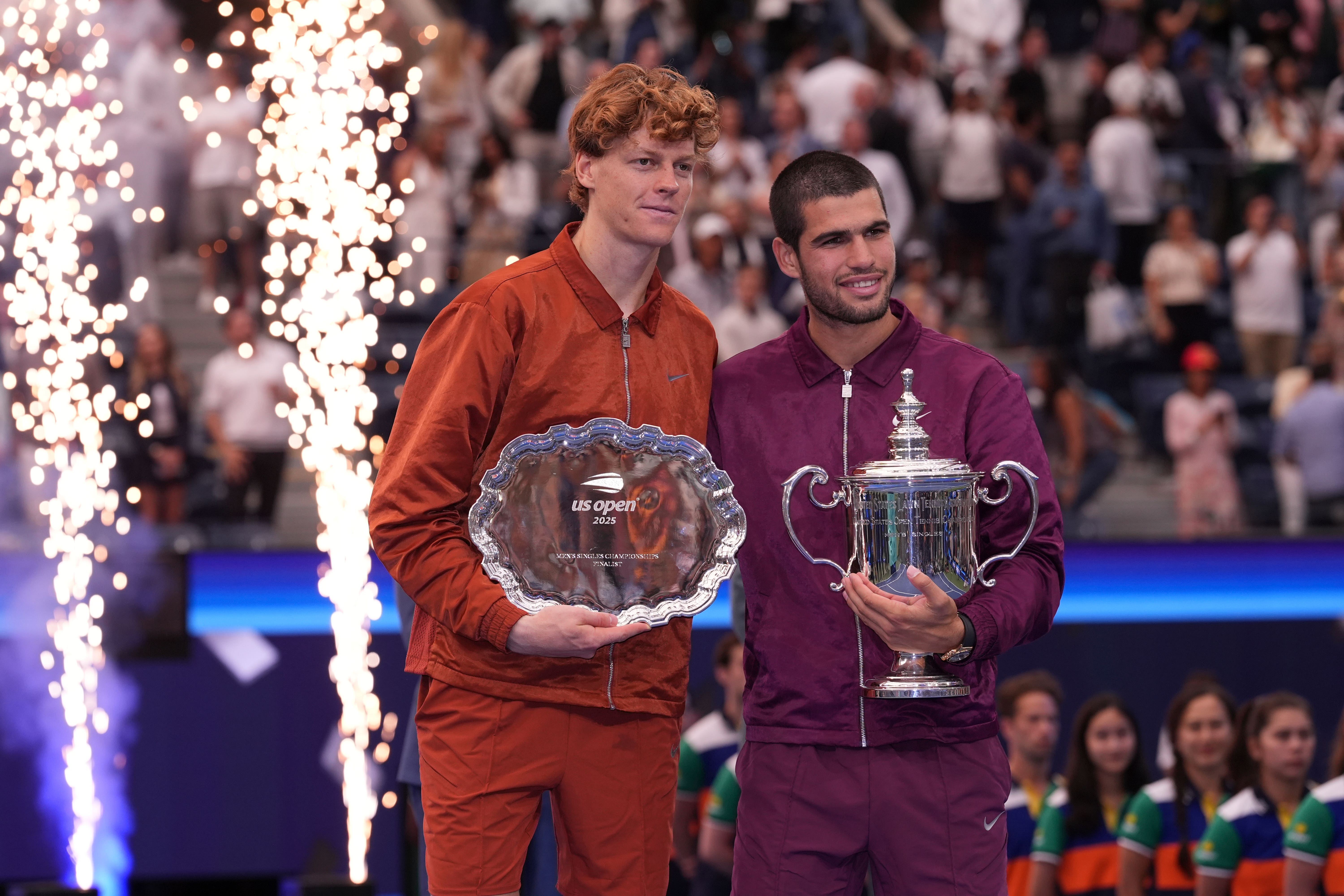 Carlos Alcaraz, right, and Jannik Sinner hold their US Open trophies (Frank Franklin II/AP)