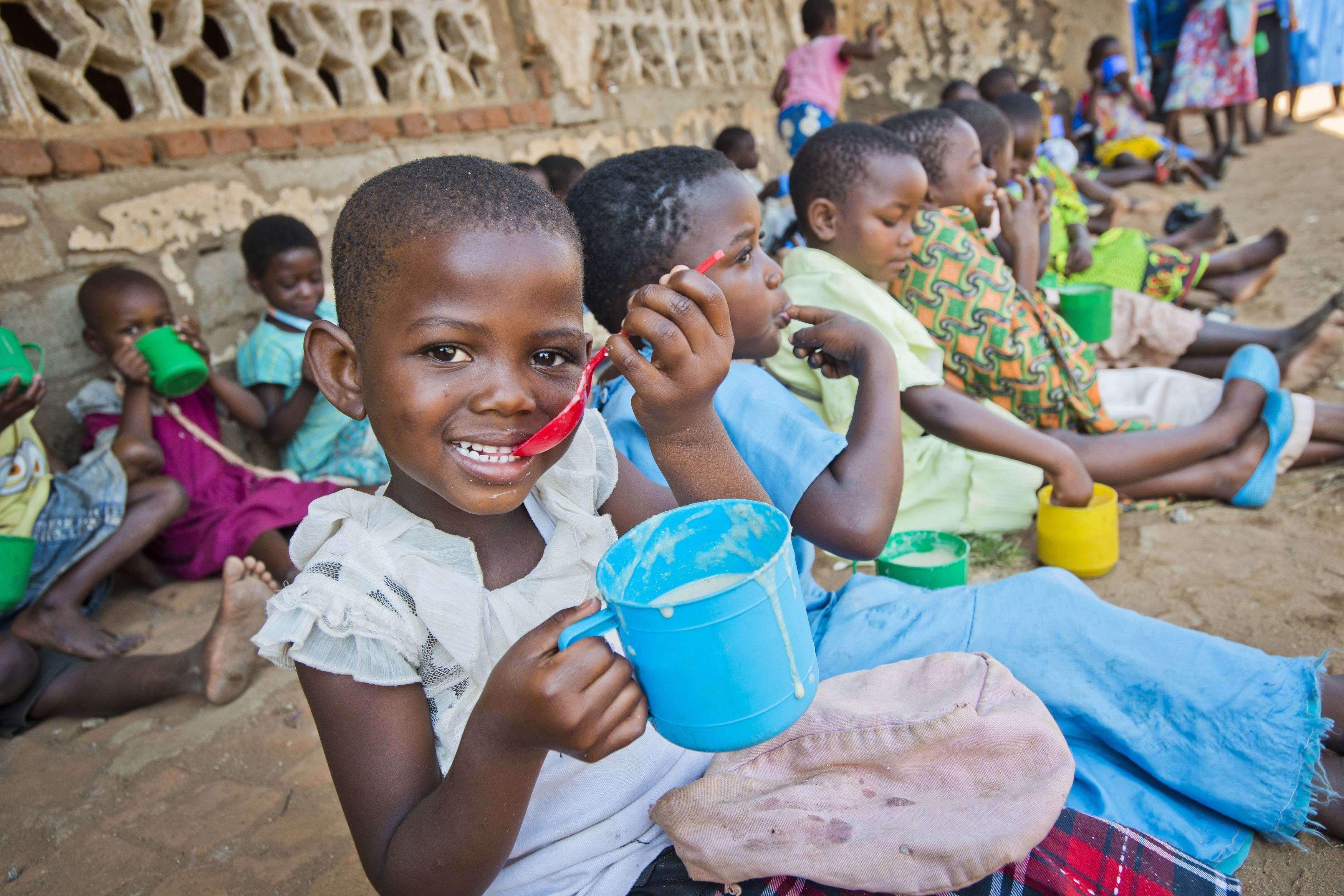 School pupils in Malawi eating porridge provided by Mary’s Meals (Chris Watt/Mary’s Meals/PA)