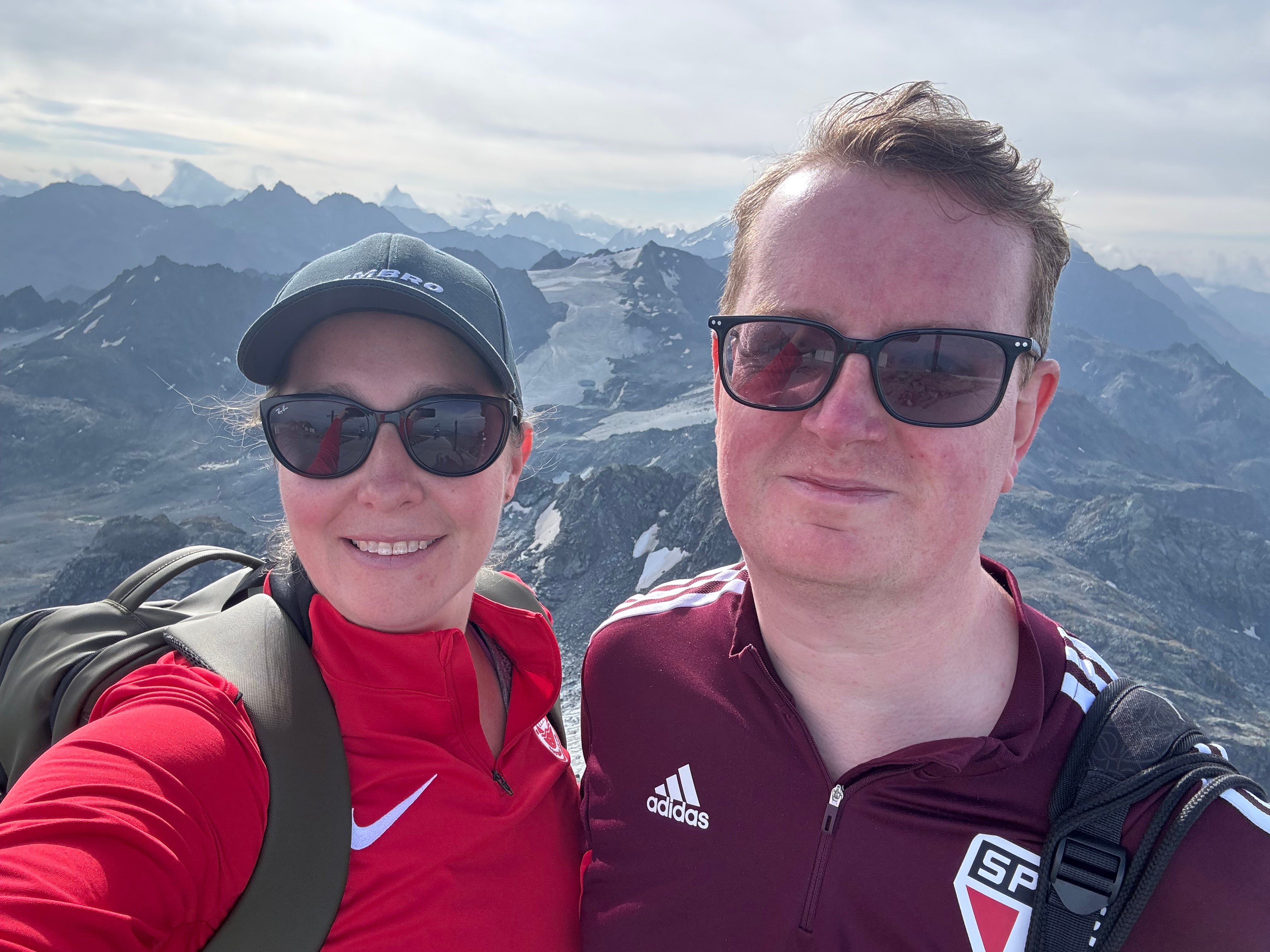 Writer Rebecca Black and her partner Andrew Scullion celebrate after reaching the summit of Mont Fort in the Swiss Alps