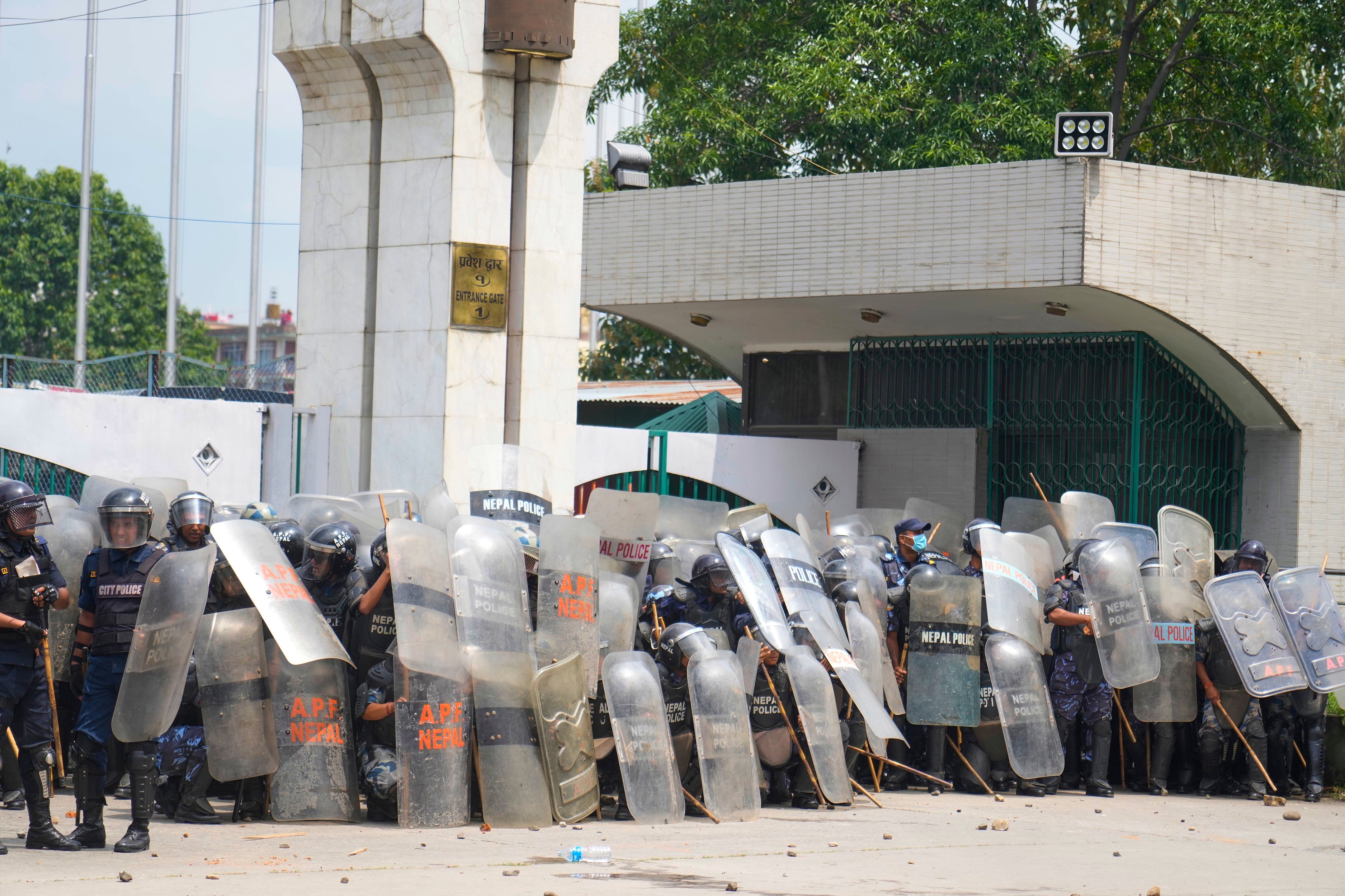 Riot police stand guard outside the parliament building as they clash with the protesters in Kathmandu, Nepal, Monday, 8 Septem 2025
