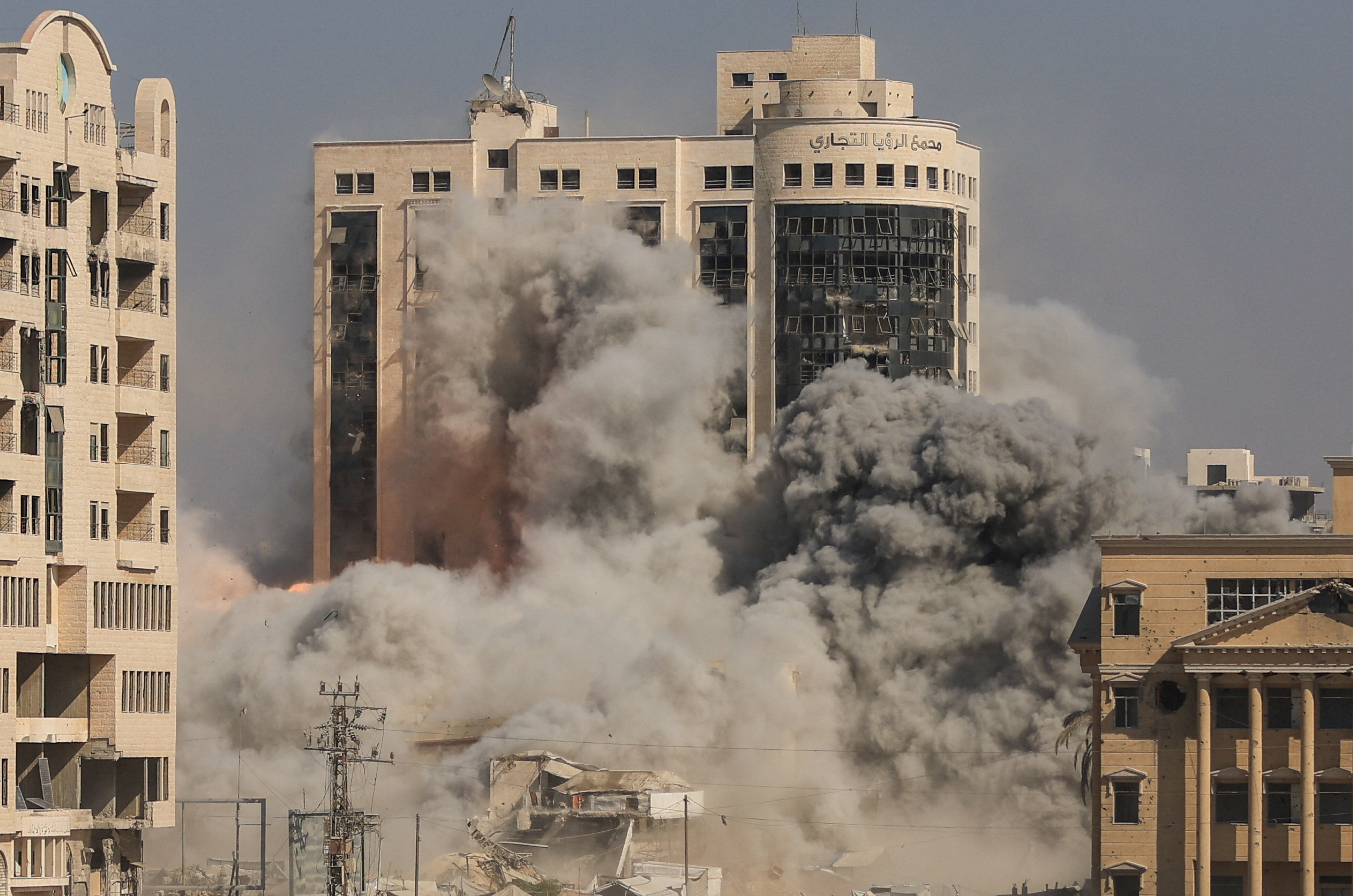 Smoke and flames rise as a residential building collapses after an Israeli airstrike, in Gaza City, 8 September