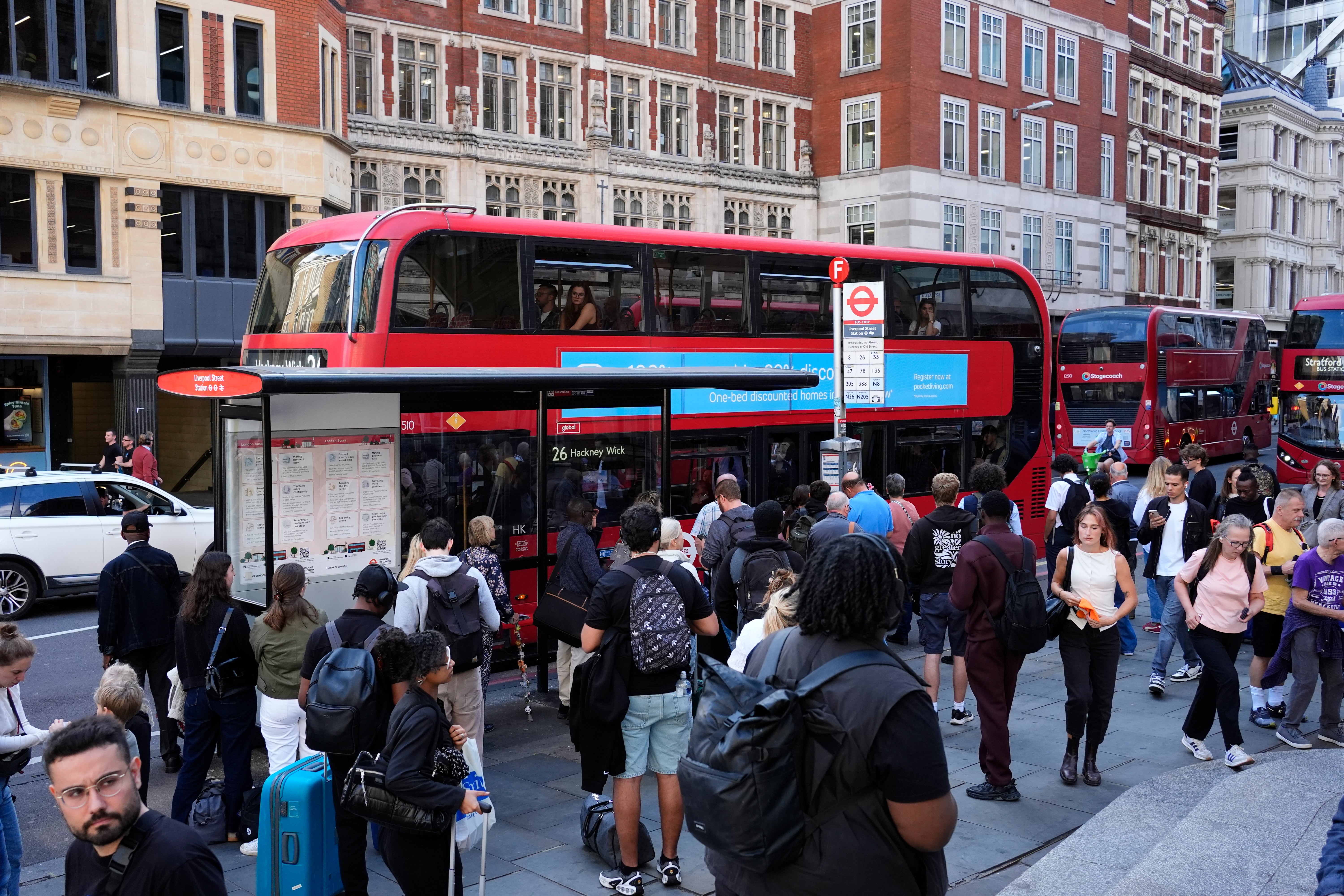 People queue for buses outside Liverpool Street station as many seek alternative transport from Underground services disrupted by strike action