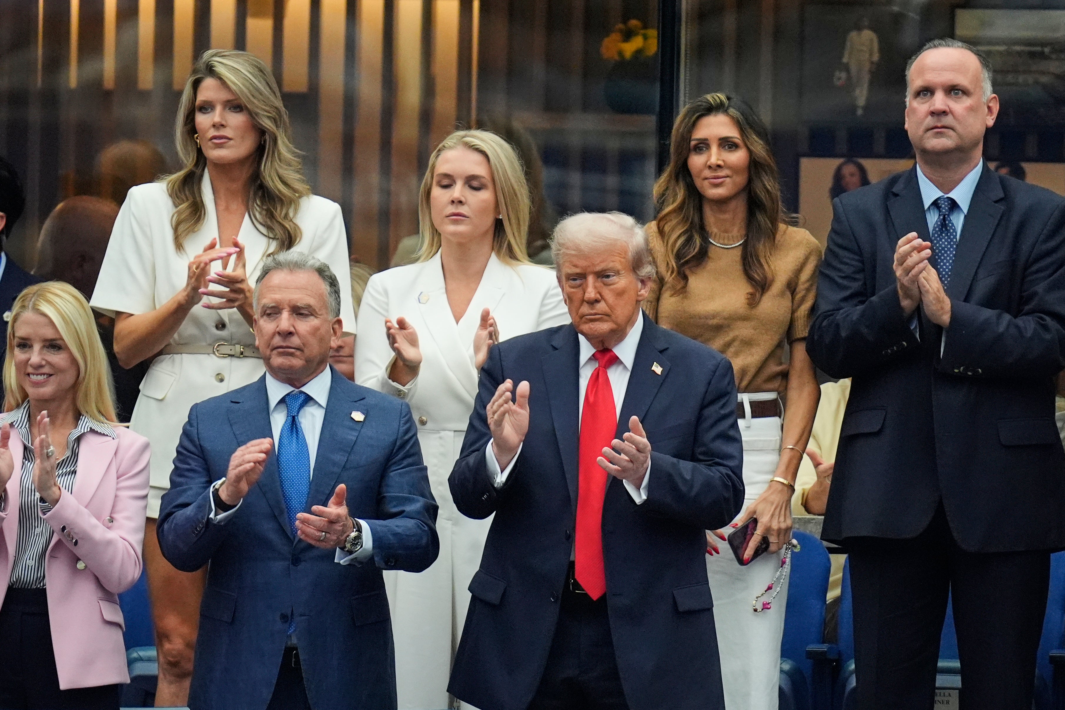 The president (center) remained stony-faced through much of the match