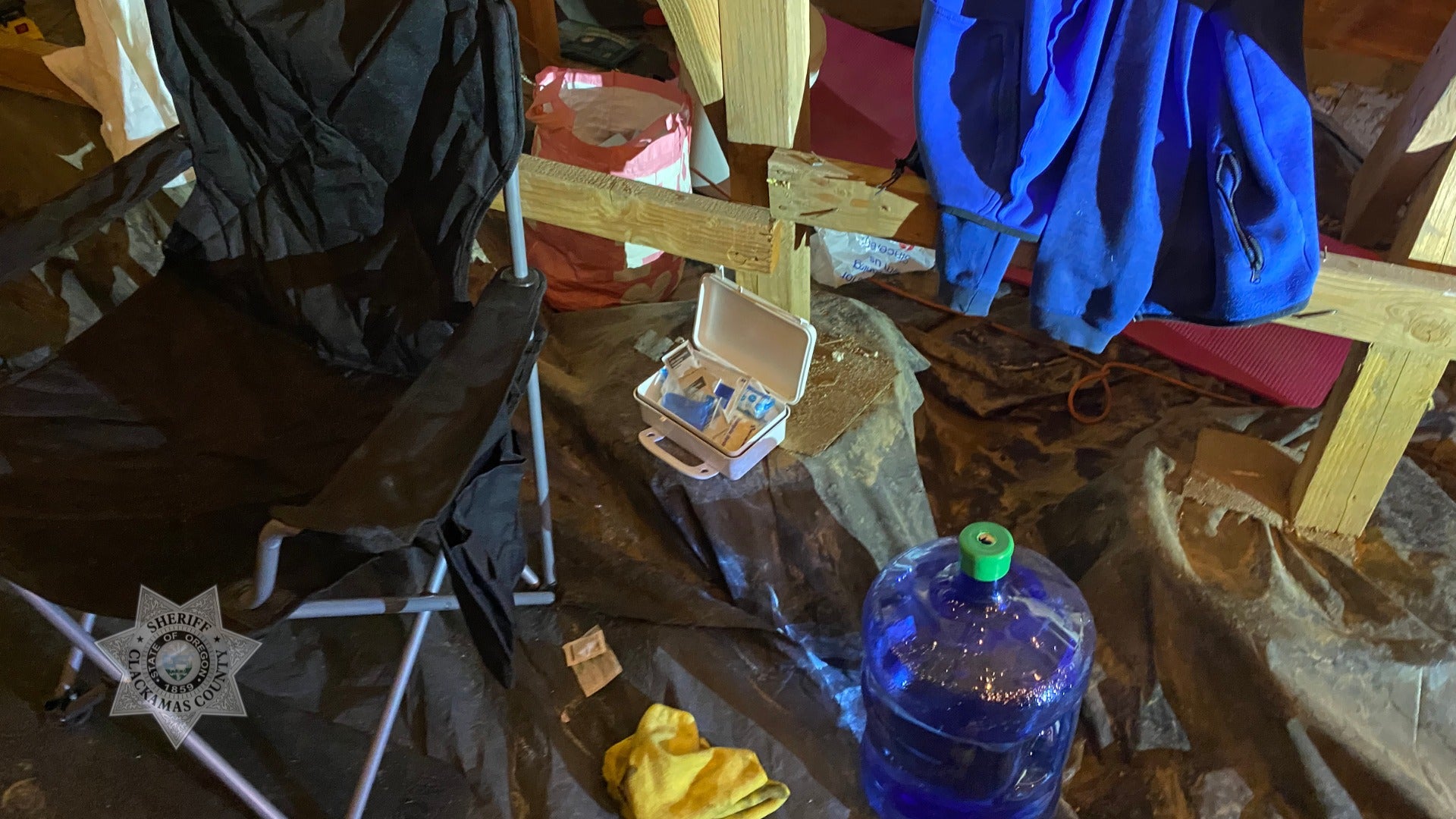 Inside the crawl space, authorities said they found a makeshift home, including a bed, TVs and electronics.