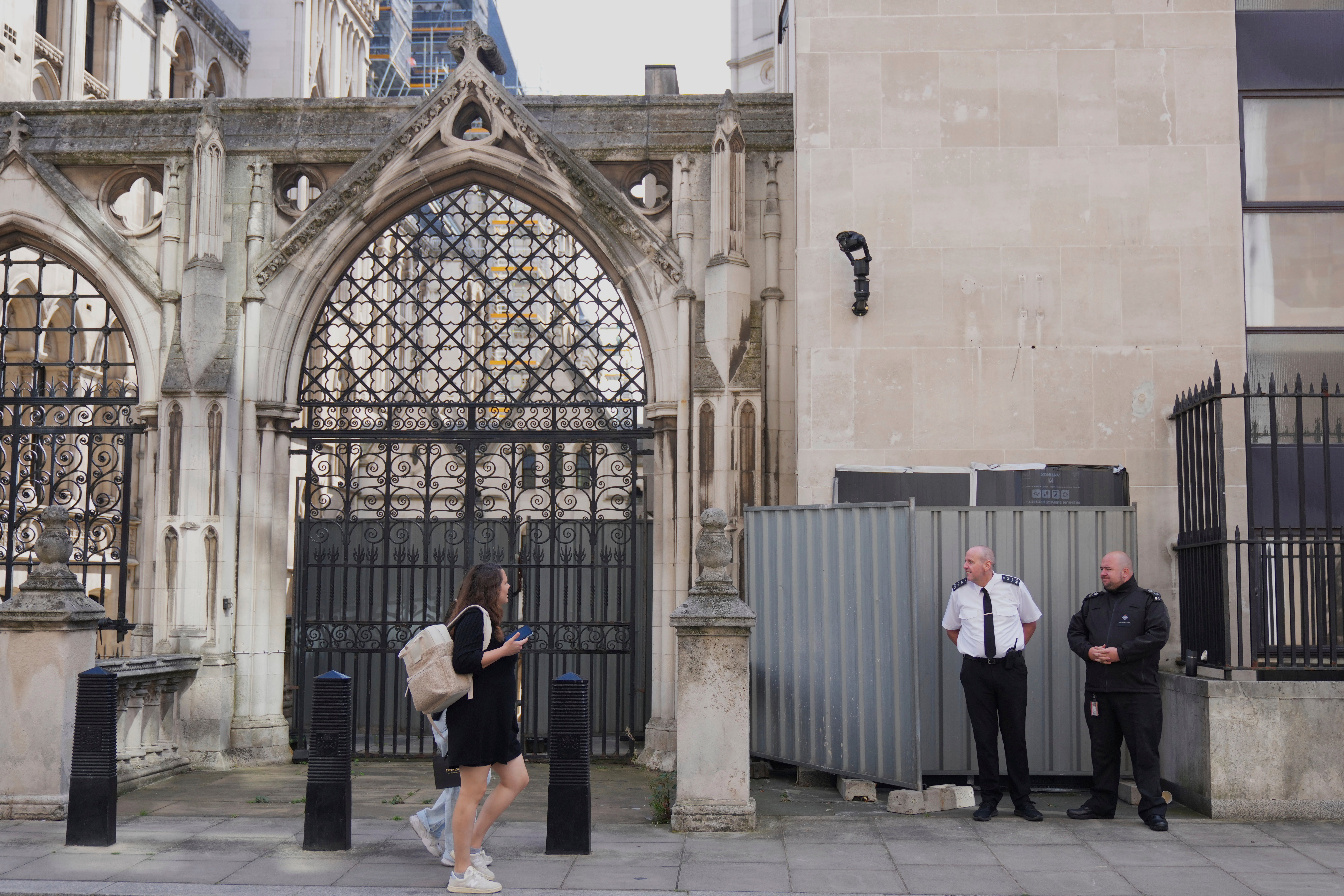 The artwork was covered up by barriers and is being guarded by security officials