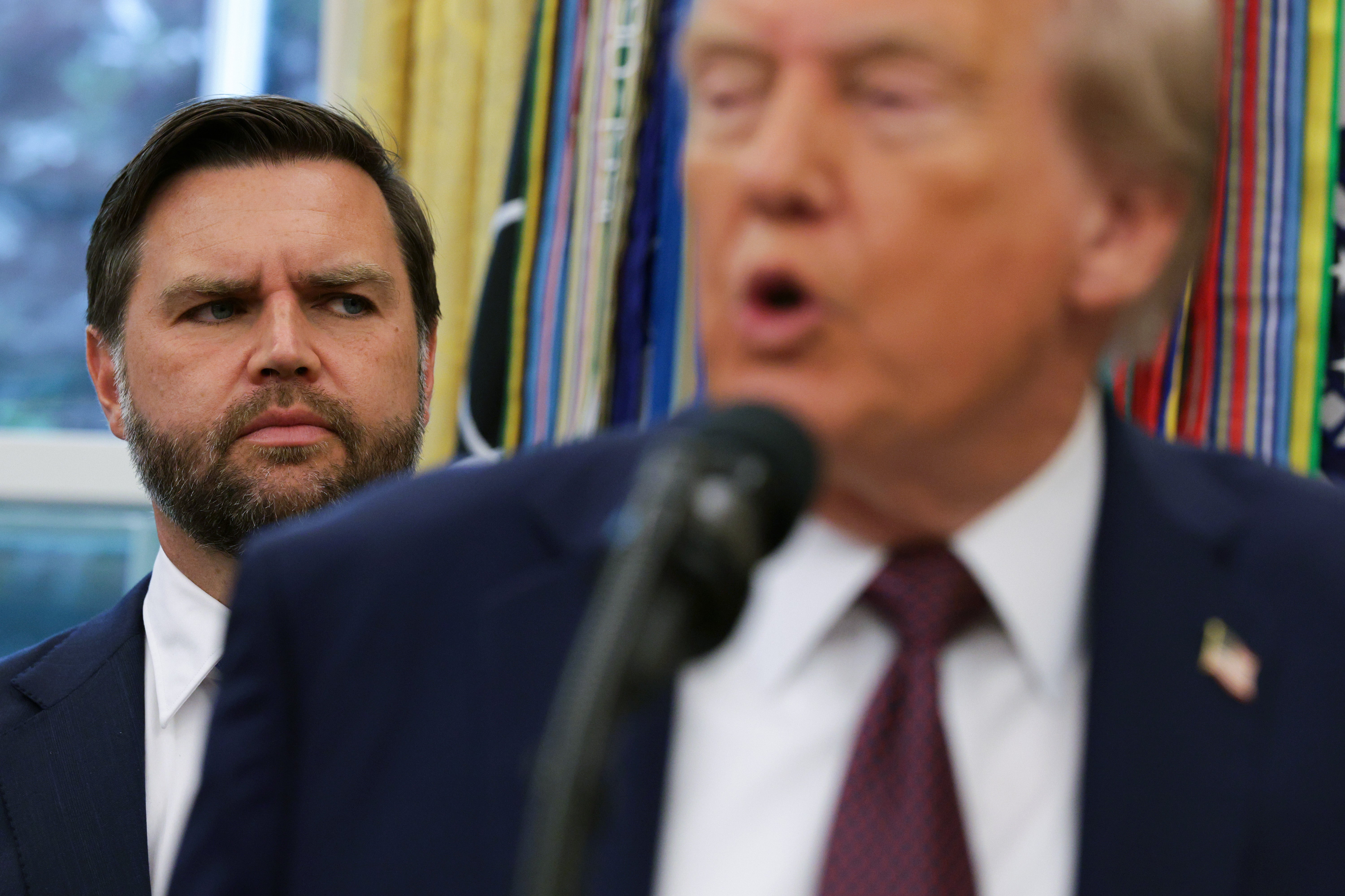 Vice President JD Vance looks on as President Donald Trump speaks to the media in the Oval Office, Trump's fundraising machine has been channeling money to Vance's political action committee