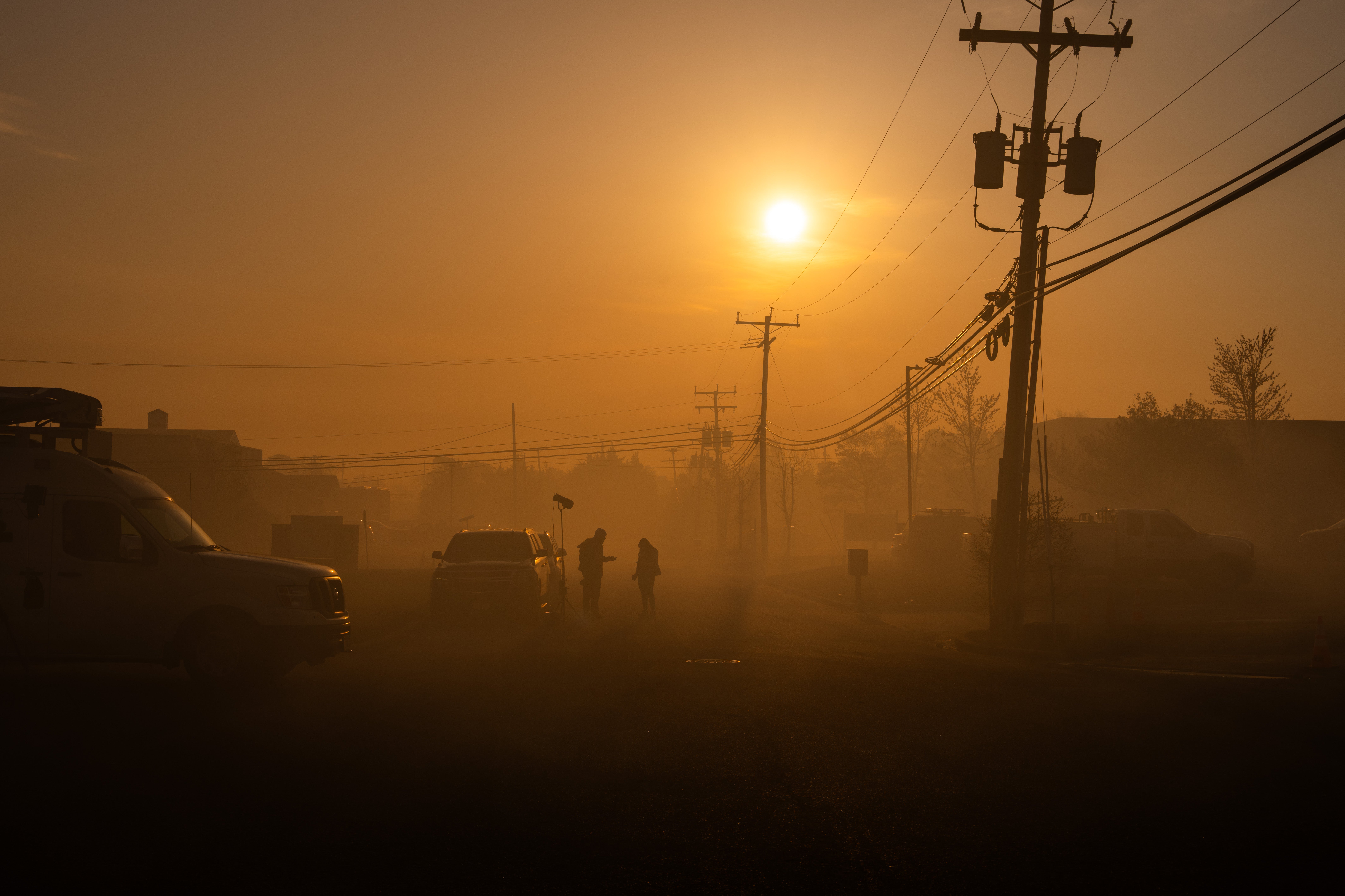A television crew is shrouded in the smoke from a wildfire last April in Forked River, New Jersey. Areas regularly affected by fires and near factories are at greater risk of the negative health effects of particulate matter