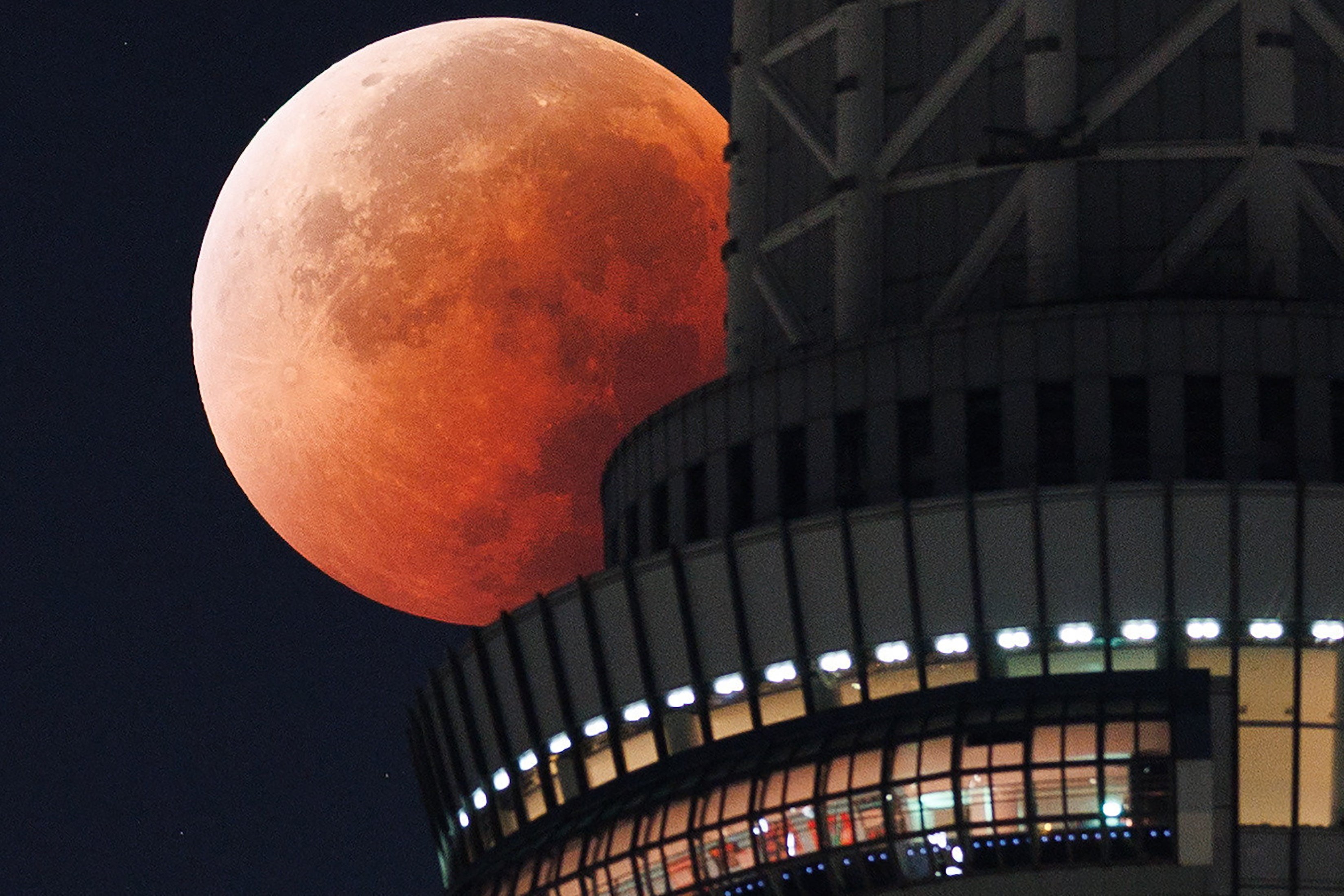 The Moon appears from behind the Tokyo Skytree during a total lunar eclipse in the middle of the night above the Japanese capital early on 8 September 2025