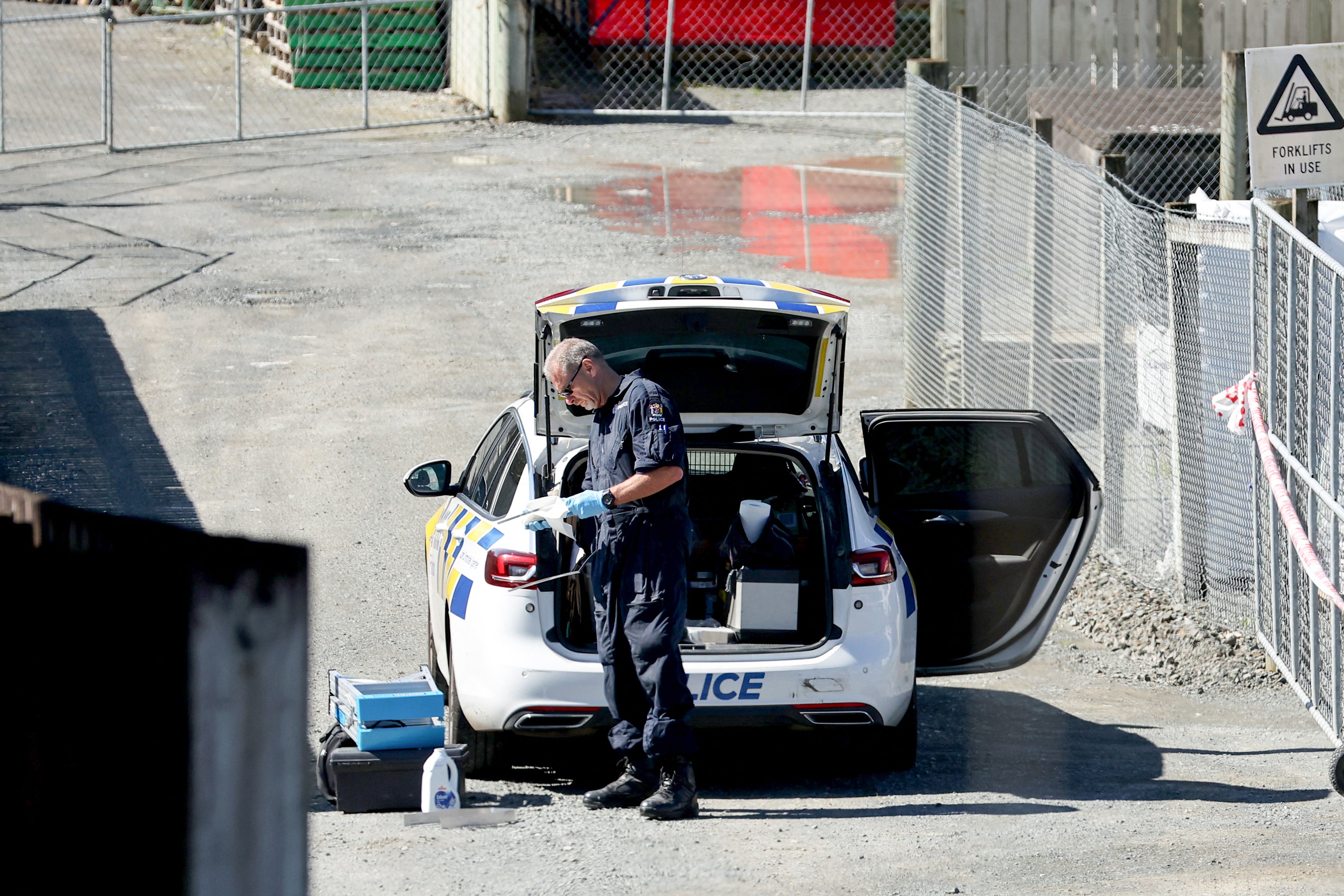 A police officer investigates a site following a shootout that occurred near the town of Piopio, located in New Zealand’s Waikato region, on 8 September 2025. A New Zealand father who spent nearly four years on the run with his children was killed in a police shootout on 8 September, authorities said. Tom Phillips, who absconded with his three children in December 2021 after a row with his former partner, died in the rolling hill country of the North Island’s Waikato region