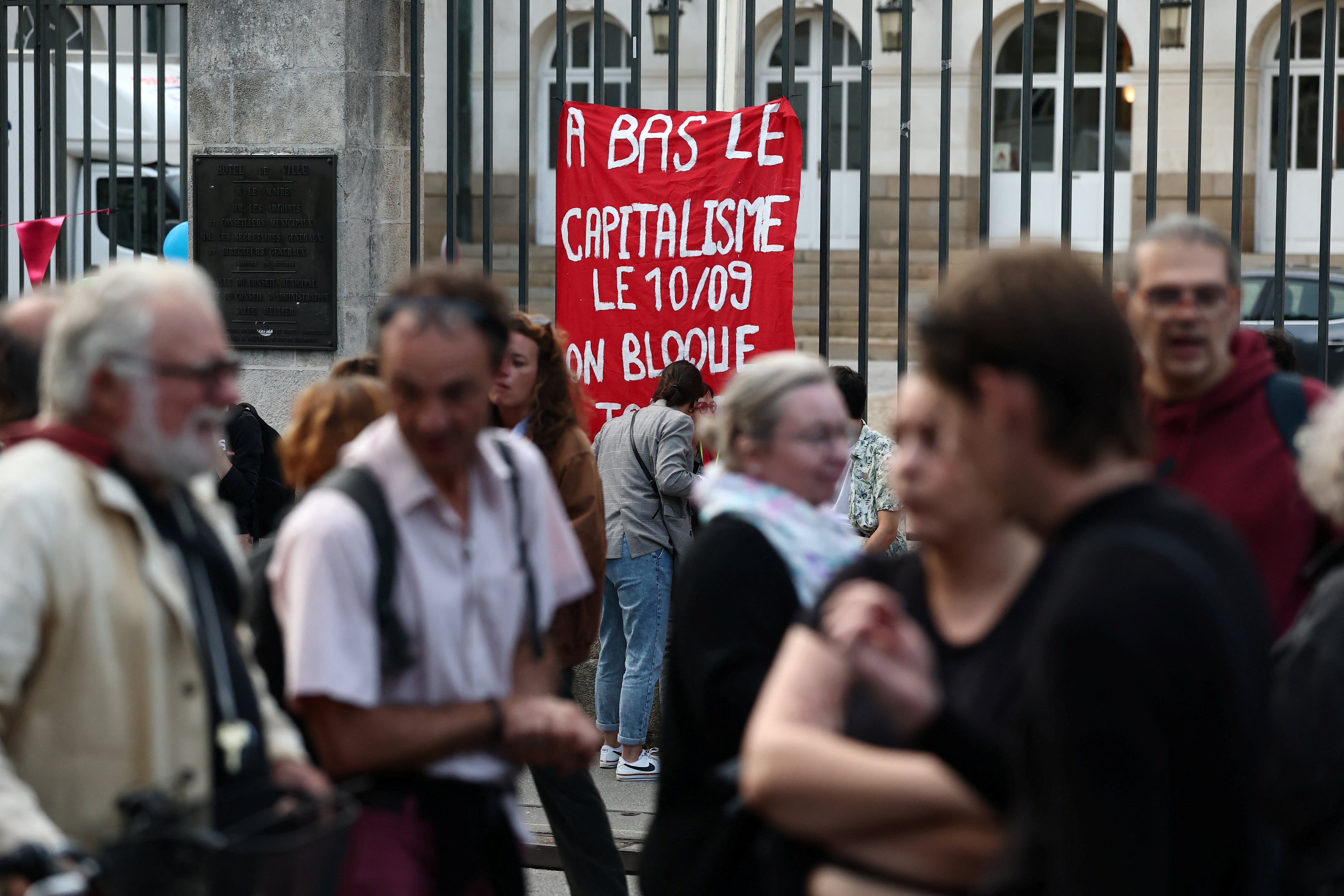Protesters in Nantes, France, celebrate the vote of no confidence