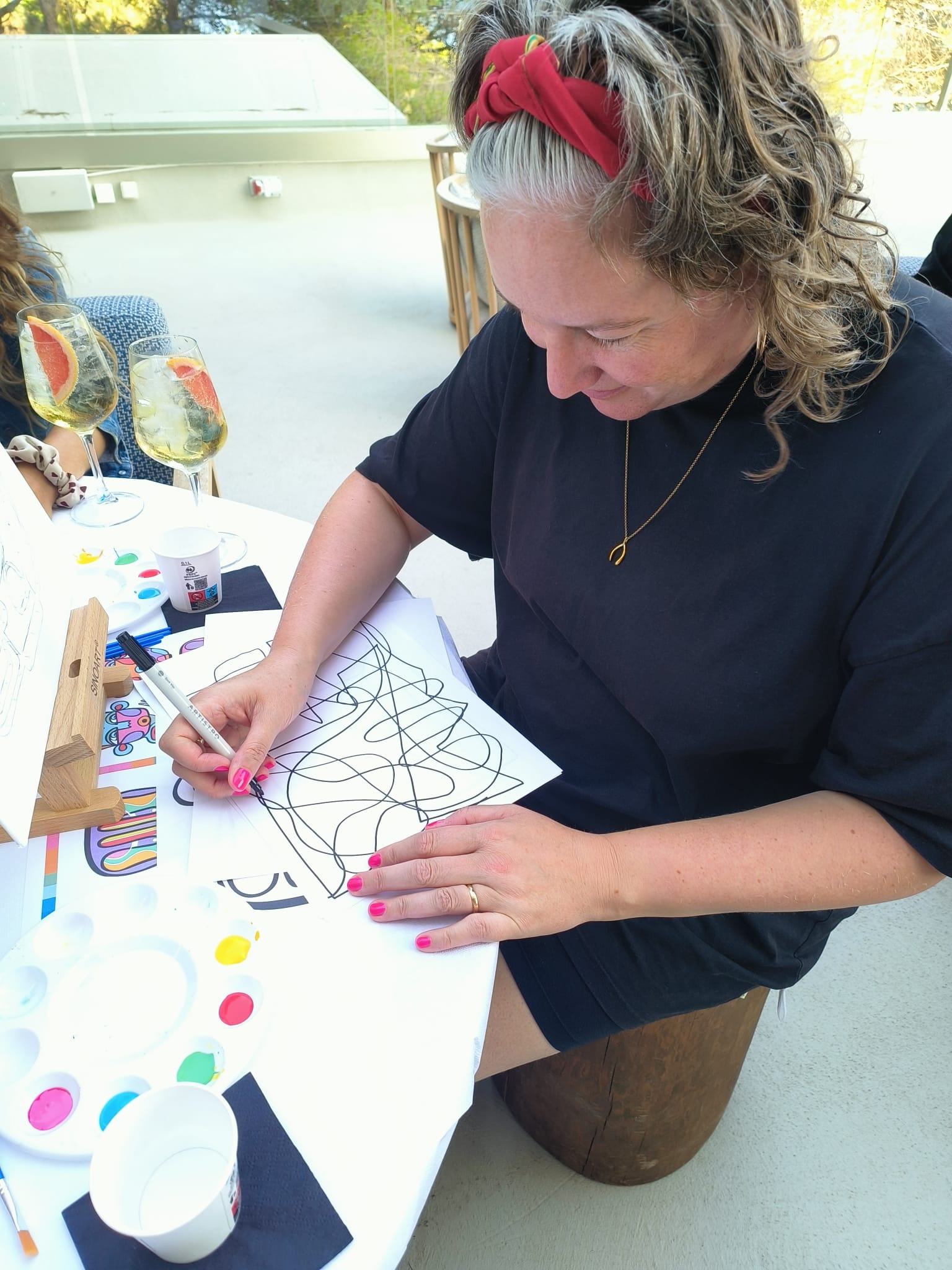 Writer Joanna Whitehead works on her continuous line drawing at Mondrian, Ibiza