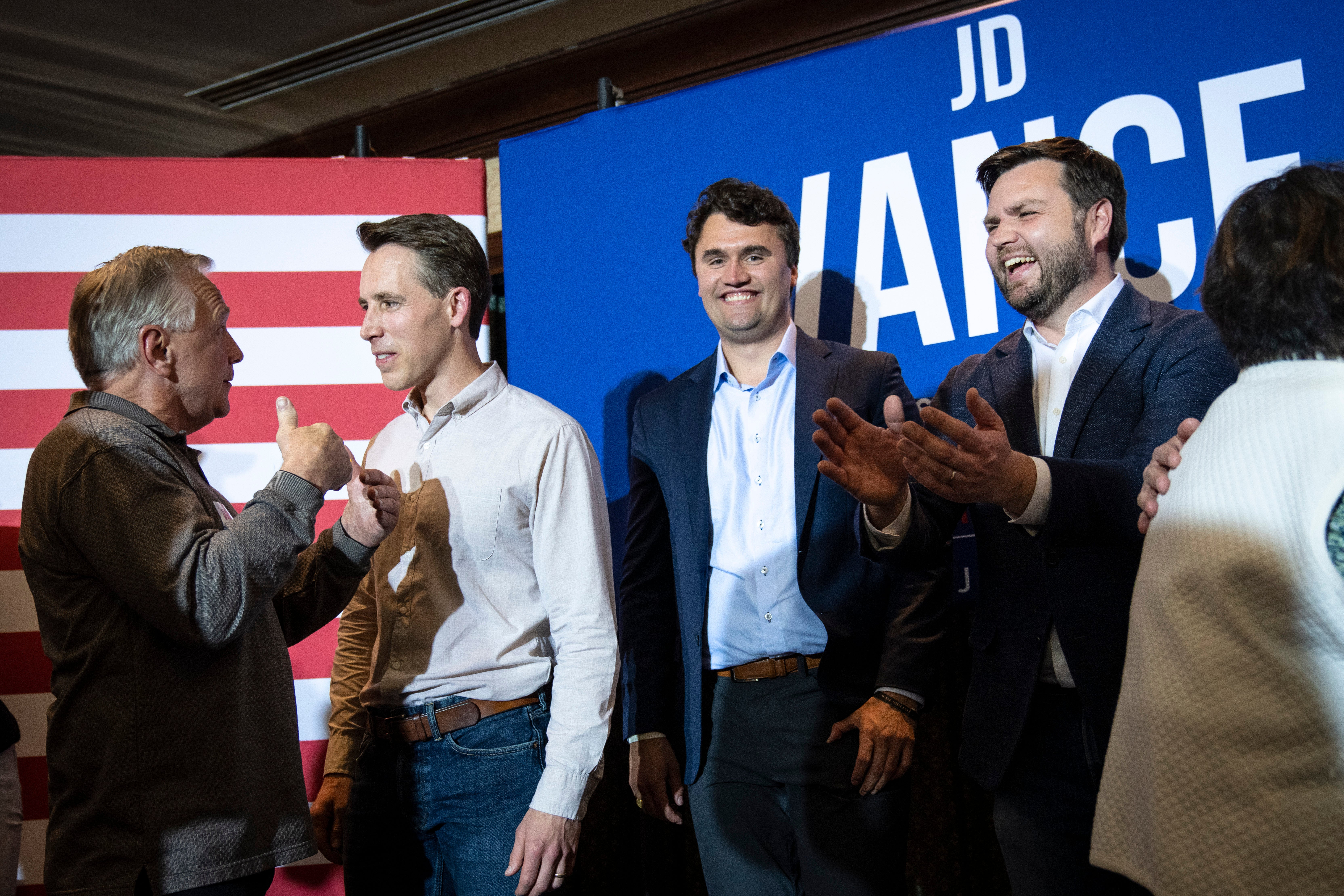 Charlie Kirk, middle right, and JD Vance, right, after a campaign rally in 2022